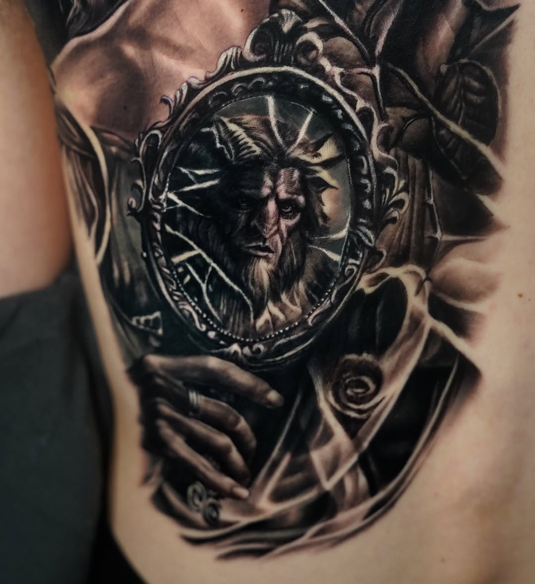 Goat-headed figure in a mirror surrealism tattoo on the chest by ๐๐๐