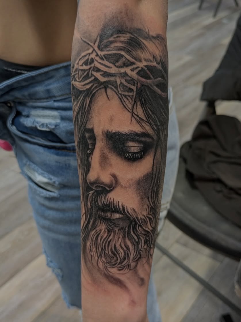 Religious figure realism tattoo on the forearm by Buddy K.