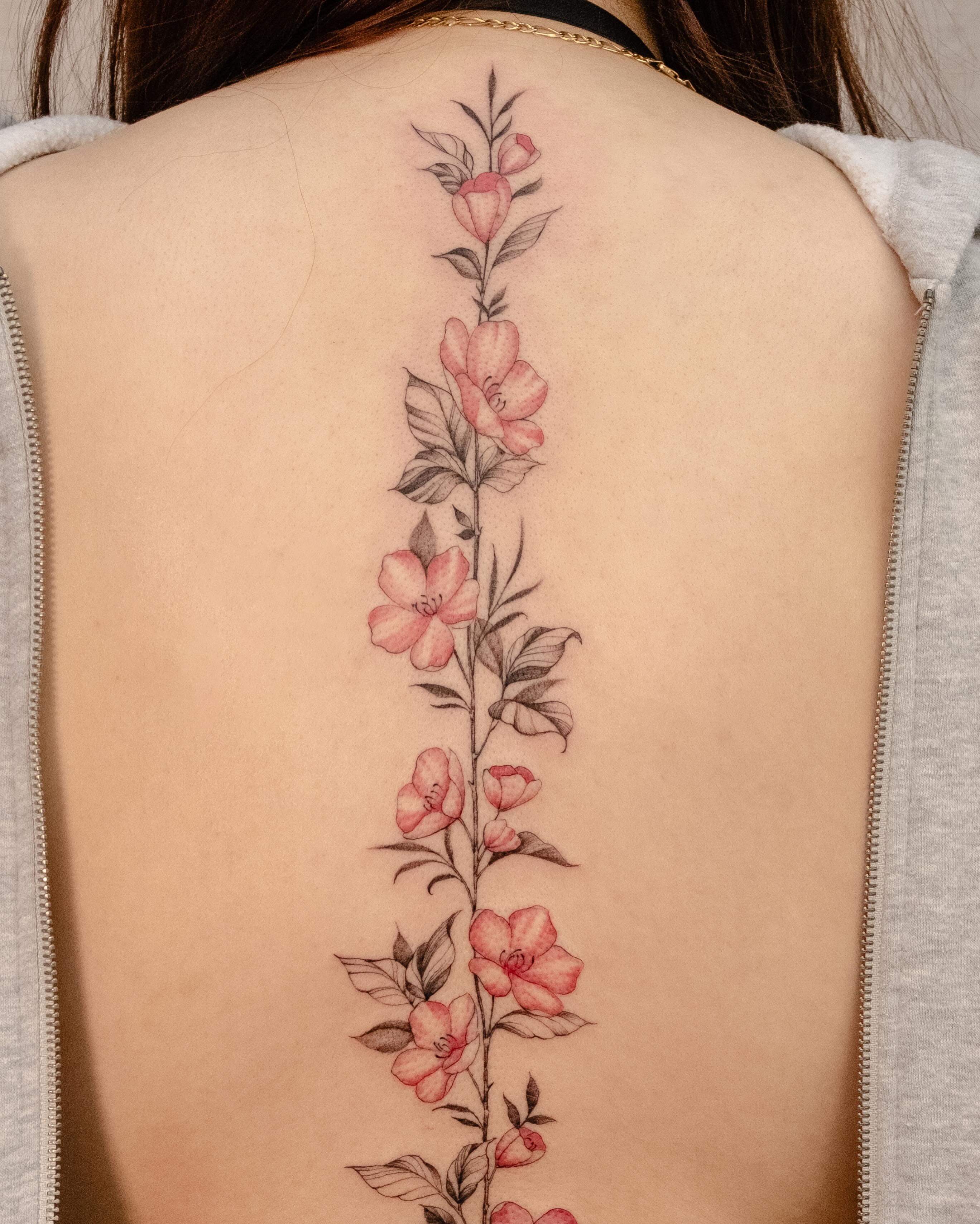 Flower vine watercolor tattoo on the back by Koko
