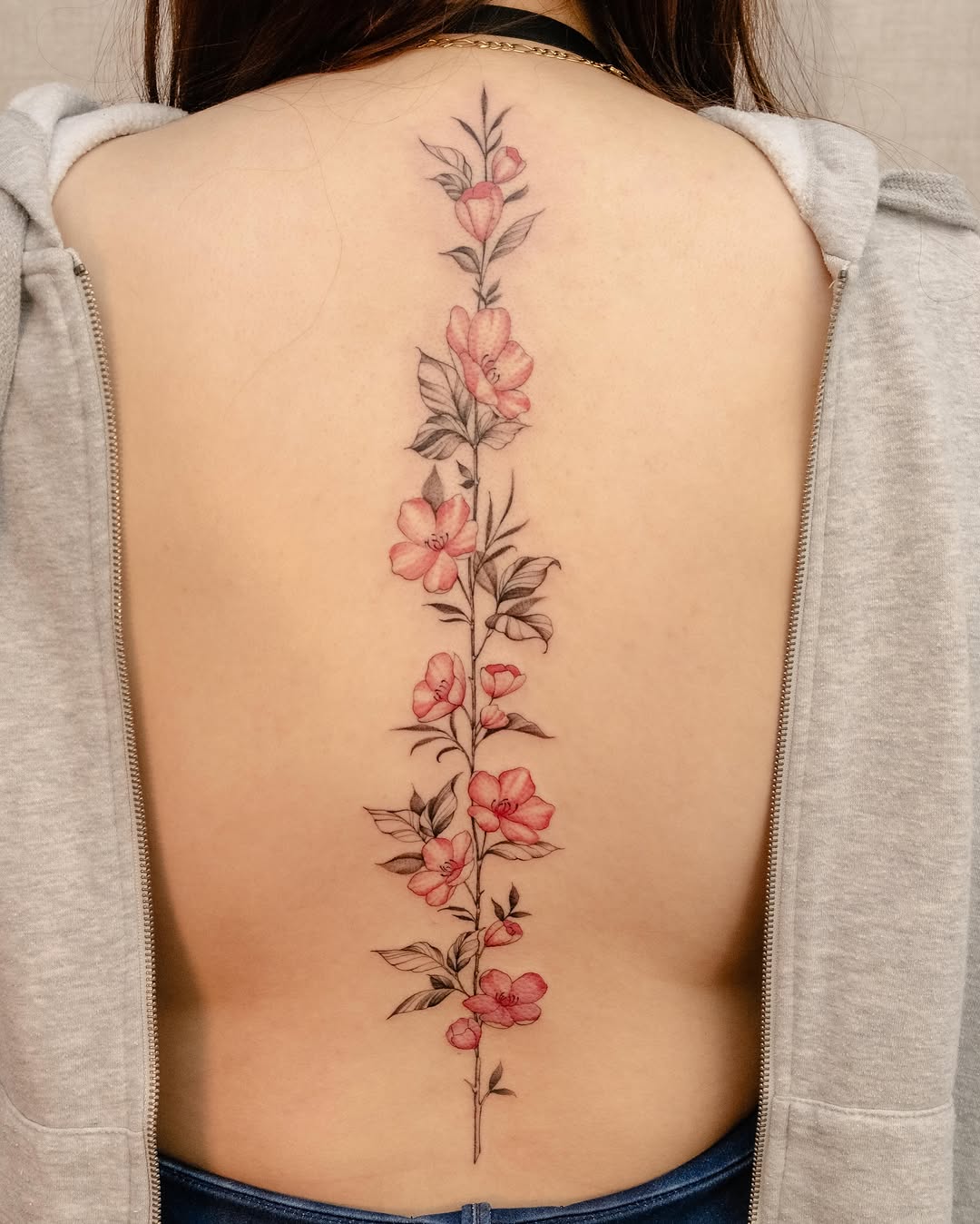 Flower vine fine line tattoo on the back by Koko