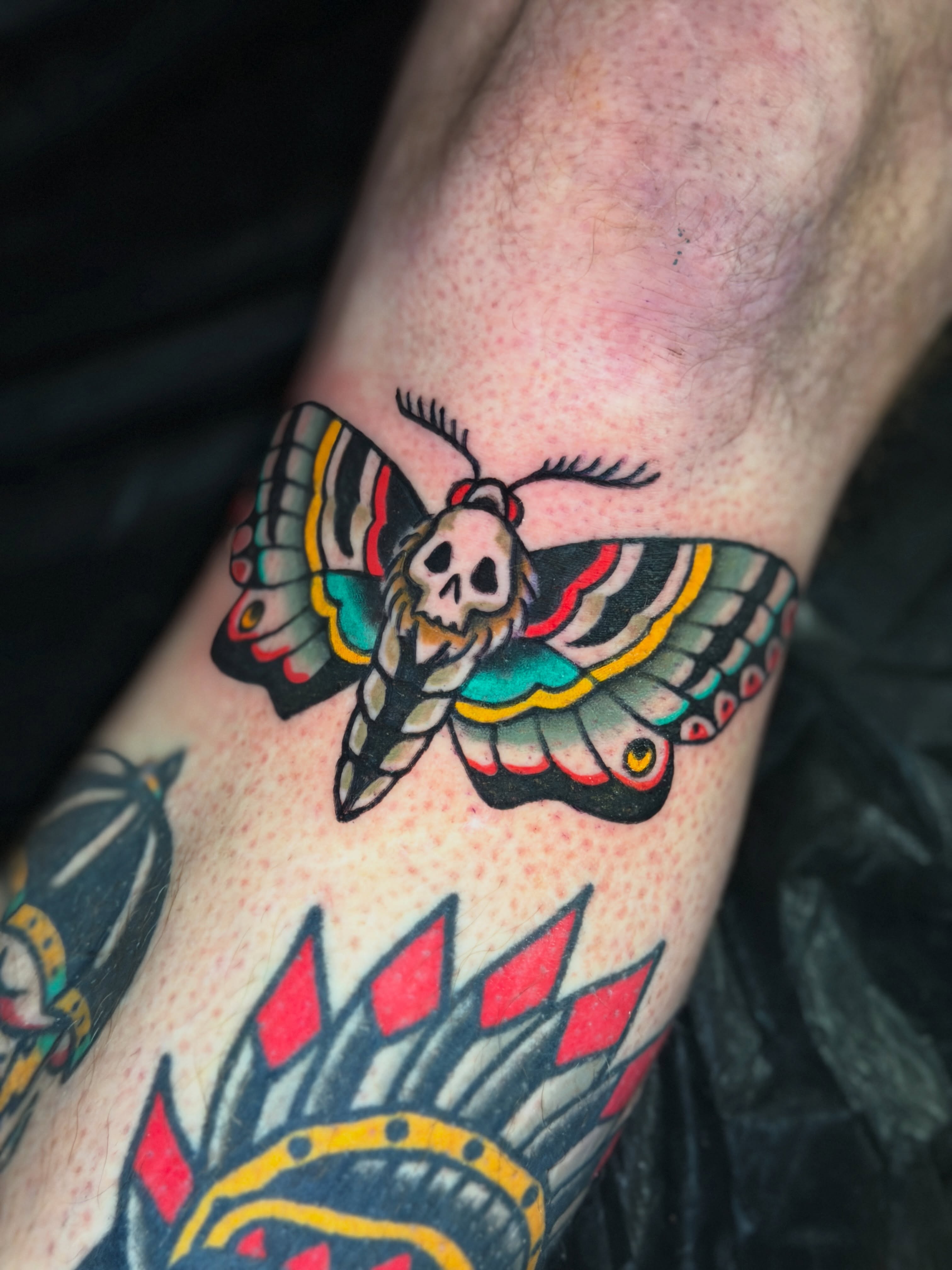 Skull moth American traditional tattoo on the forearm by R e N O T