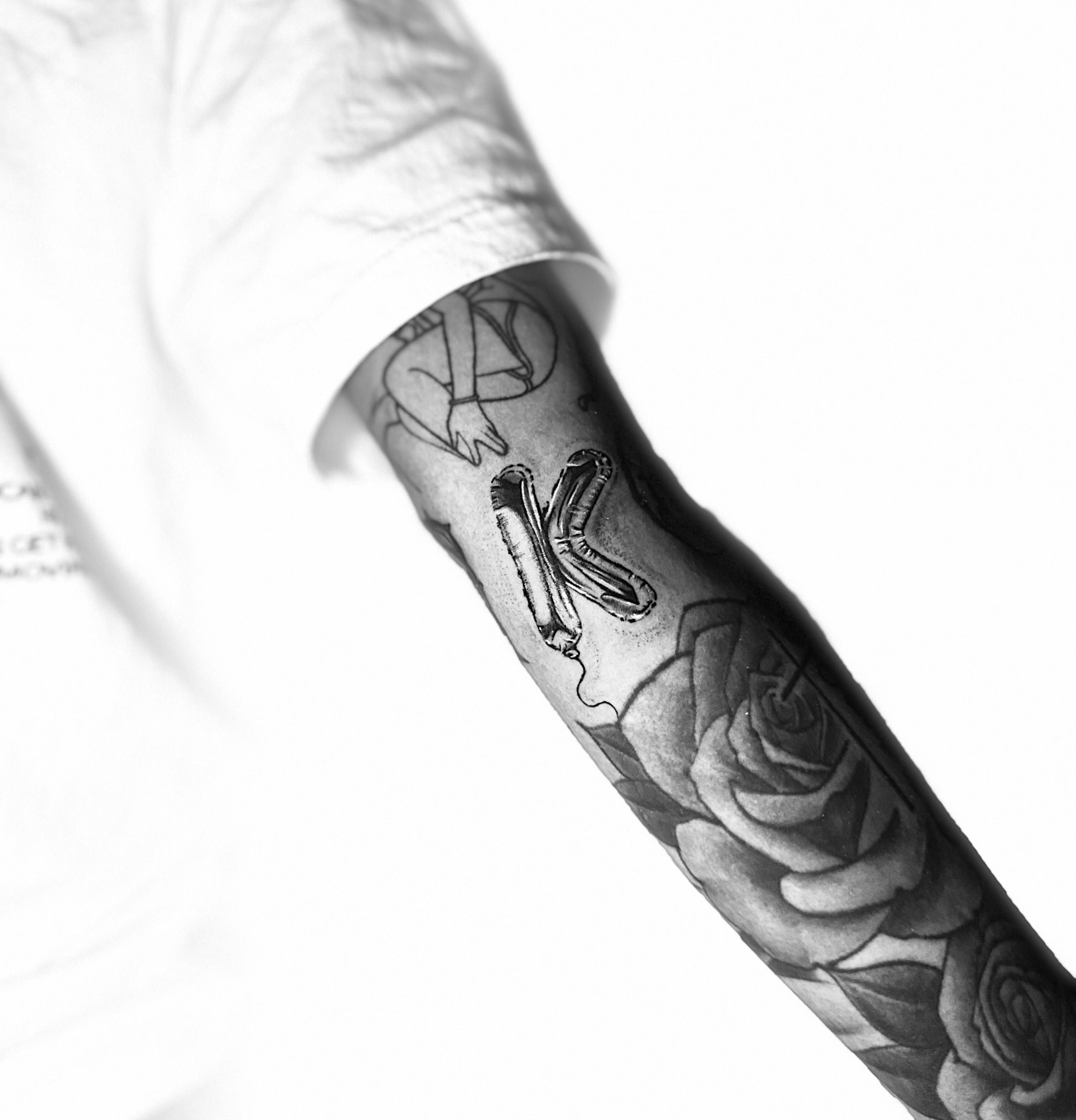 Roses and snake black and grey tattoo on the forearm by Giana Martinez, Wichita, Kansas