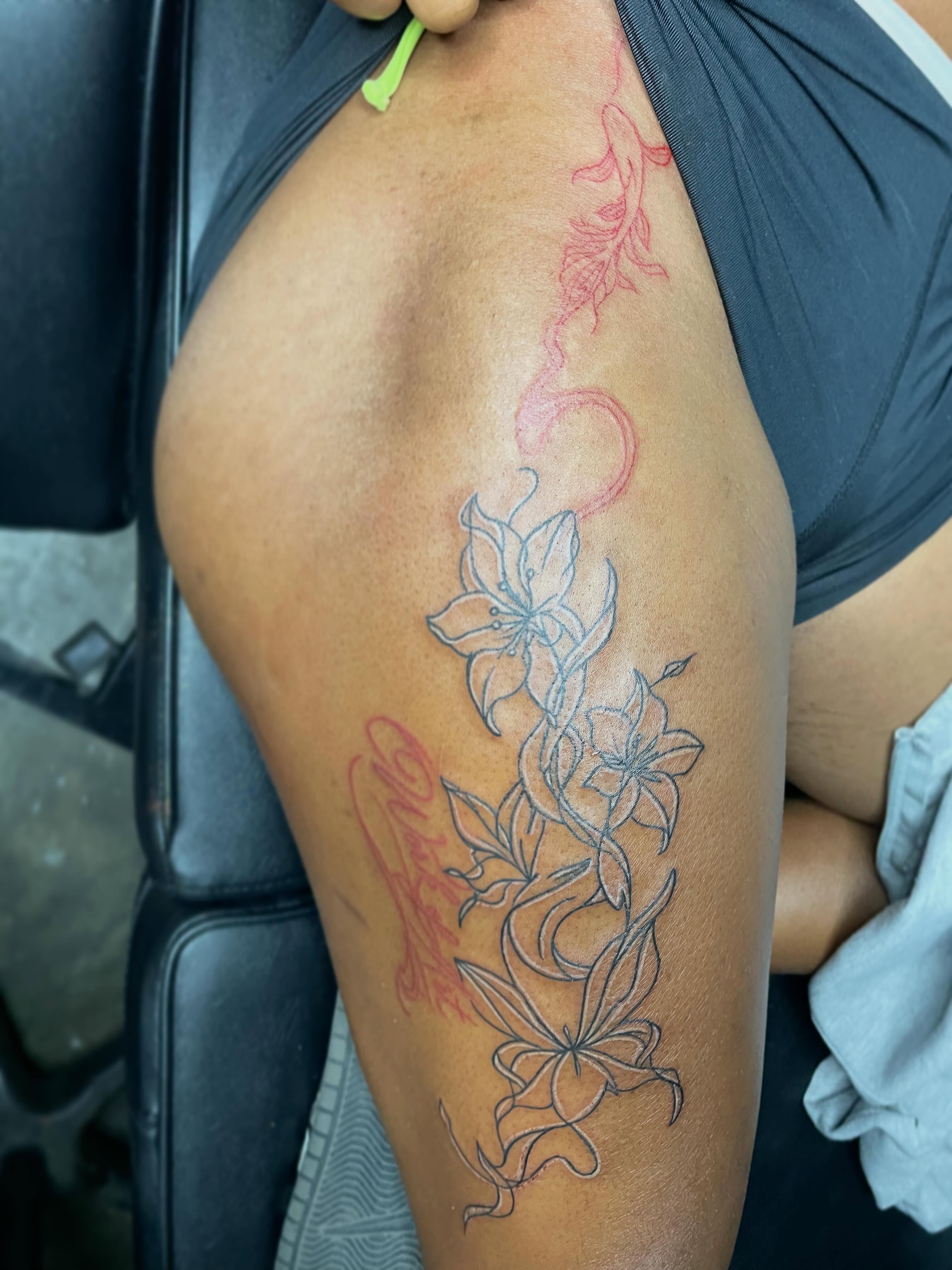 Lilies fine line tattoo on the upper arm by TreCashTats💉🩸 MisfitzTattooStudio