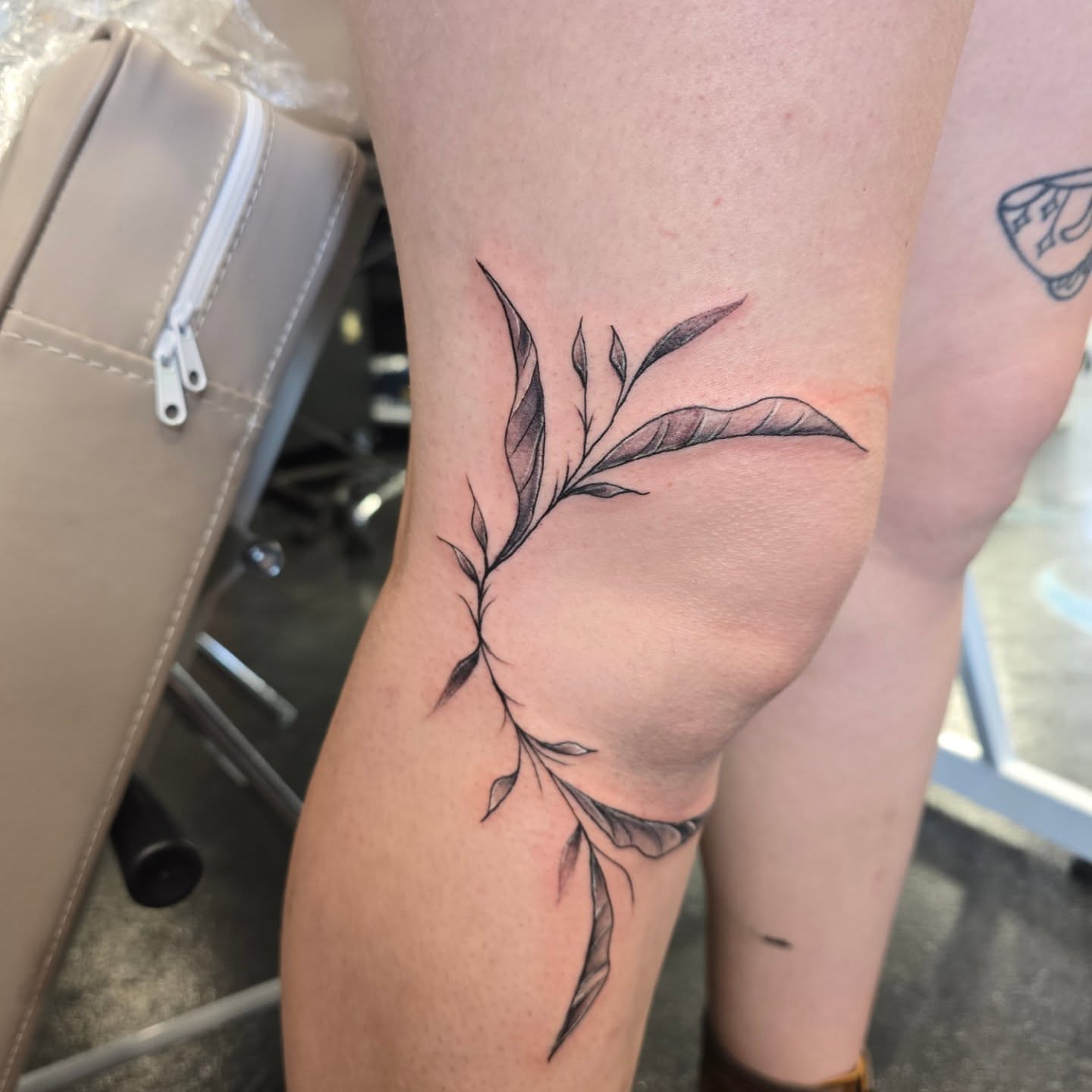 Branch with leaves black and grey tattoo on the forearm by Maddox Kitson🕷