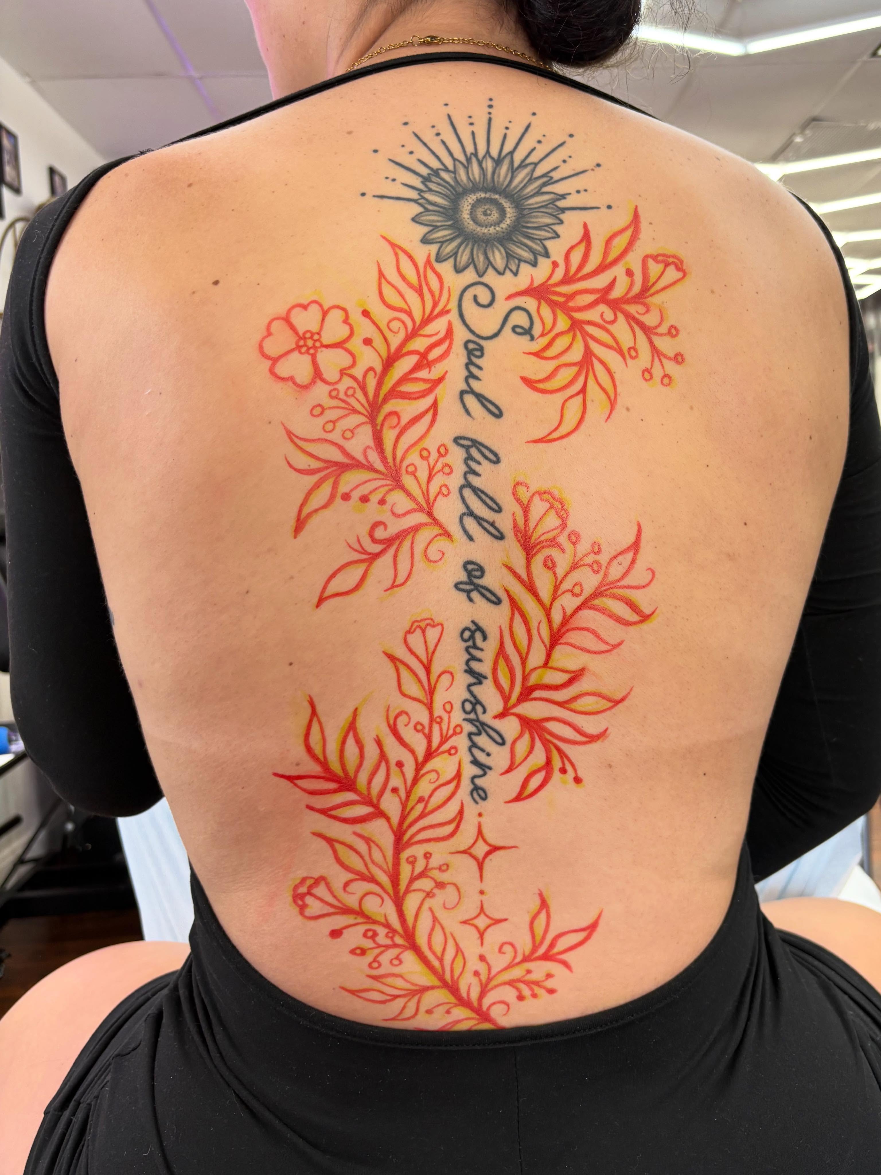 Floral cross dotwork tattoo on the back by Skye California