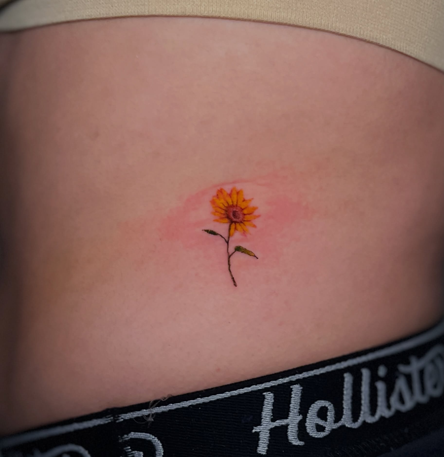 Sunflower watercolor tattoo on the torso by Eleana, North Miami, Florida