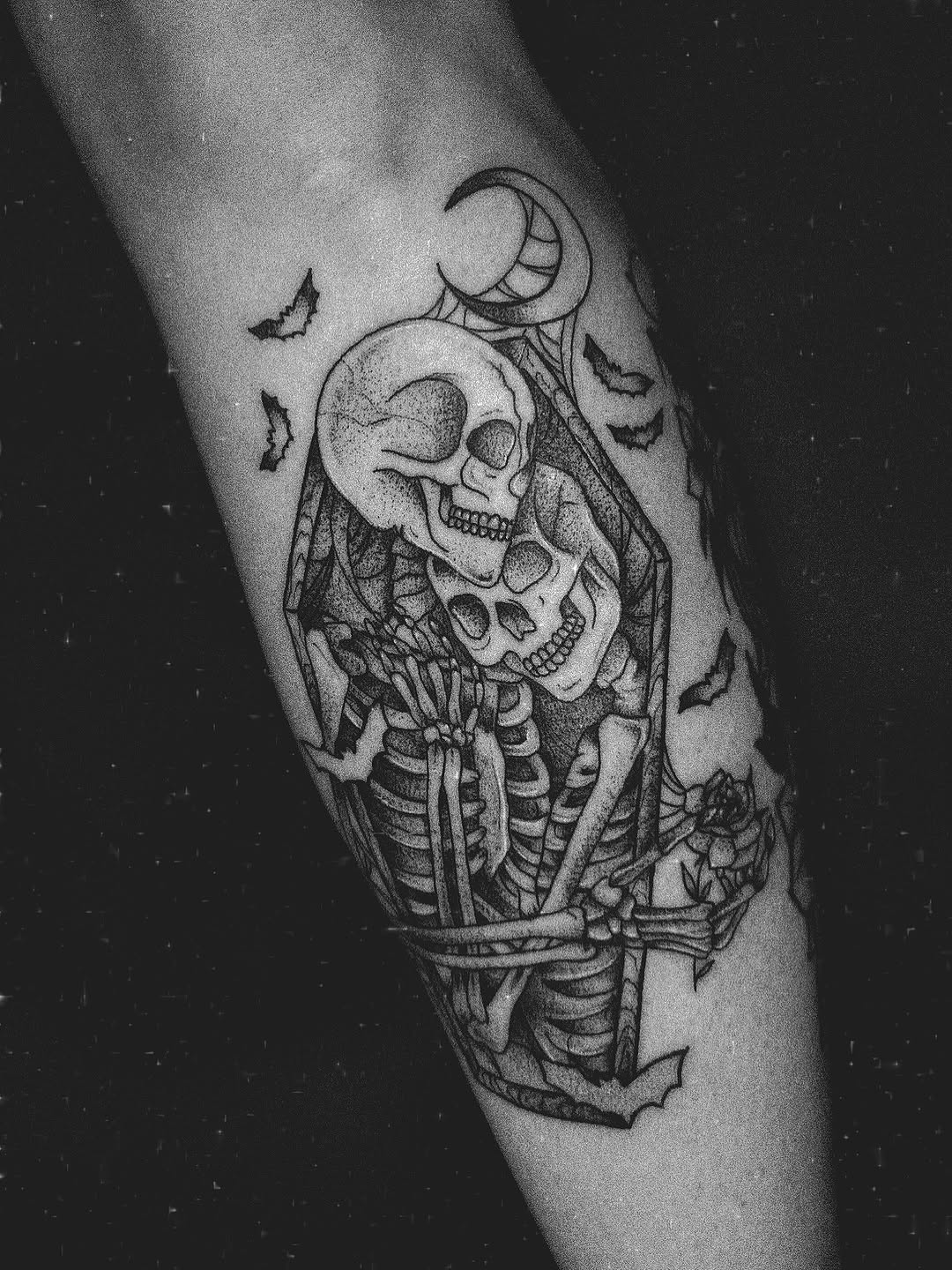 Two skeletons embracing realism tattoo on the forearm by E L I Z A H B e T H H D e S I G N S