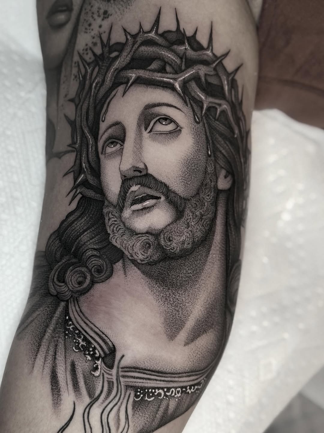 Jesus with crown of thorns realism tattoo on the forearm by Luna Lucero