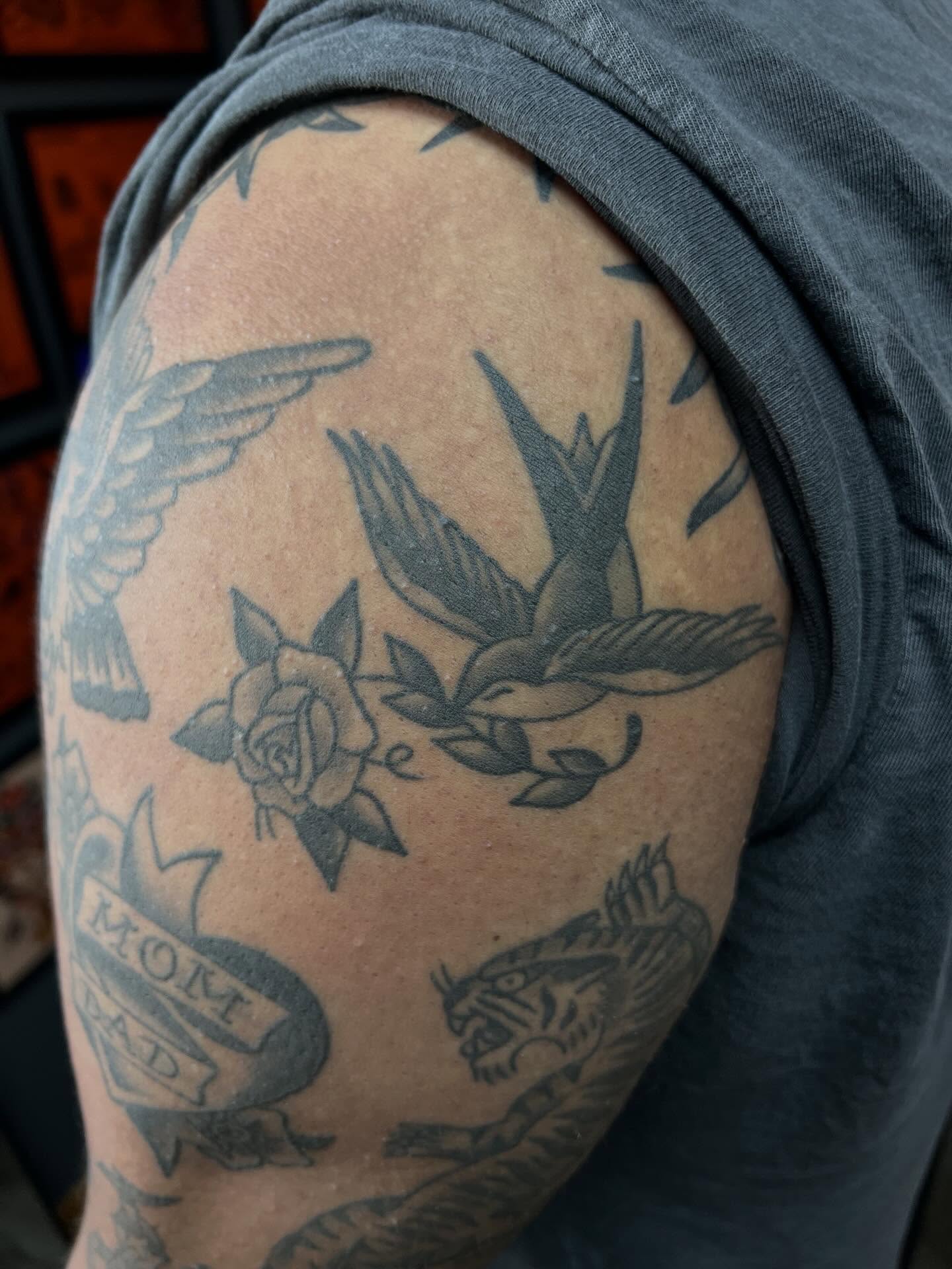 Swallow and rose American traditional tattoo on the shoulder by Tyler Van Pelt