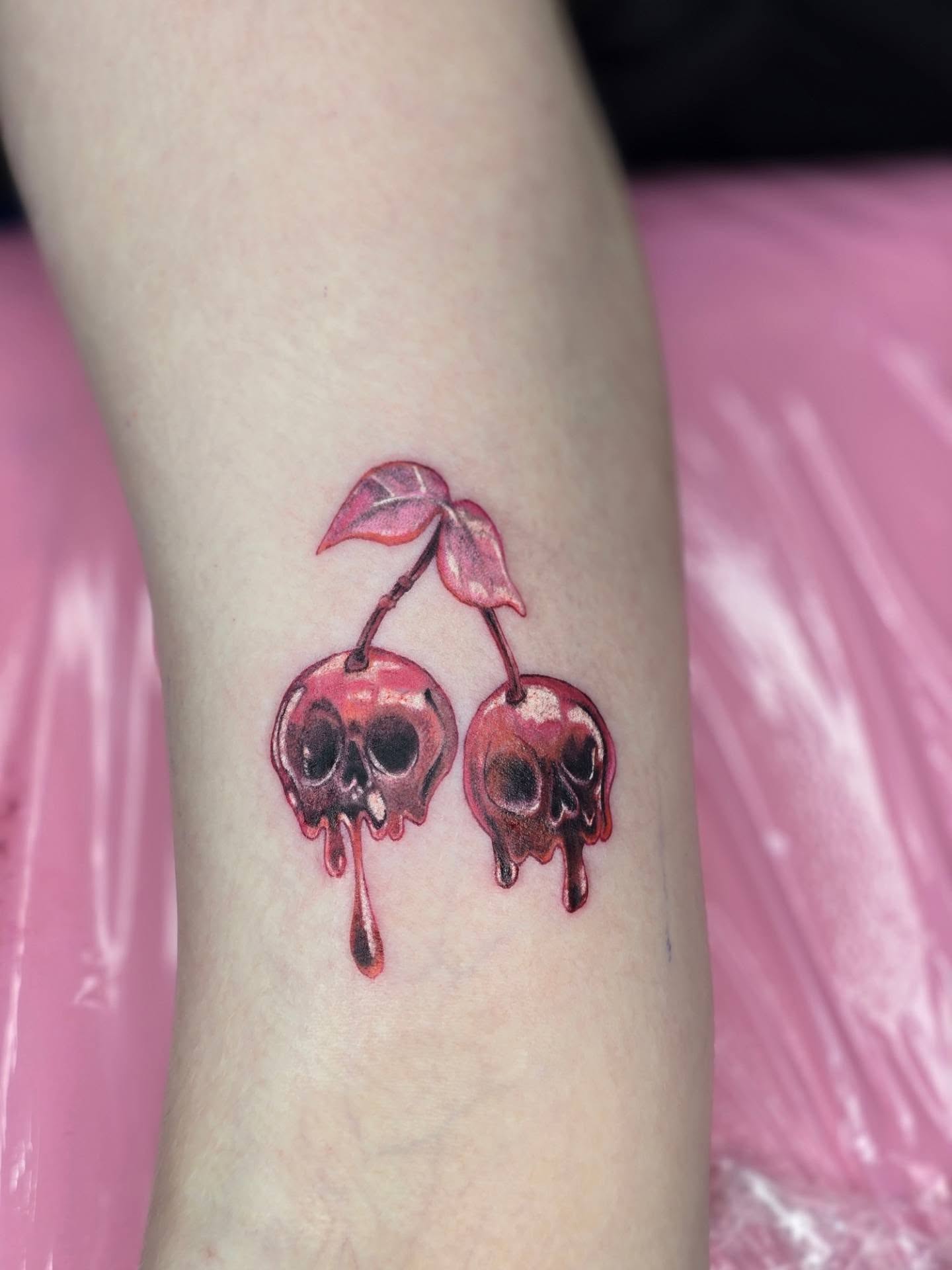 Cherry skulls realism tattoo on the forearm by Rachel, Centereach, New York