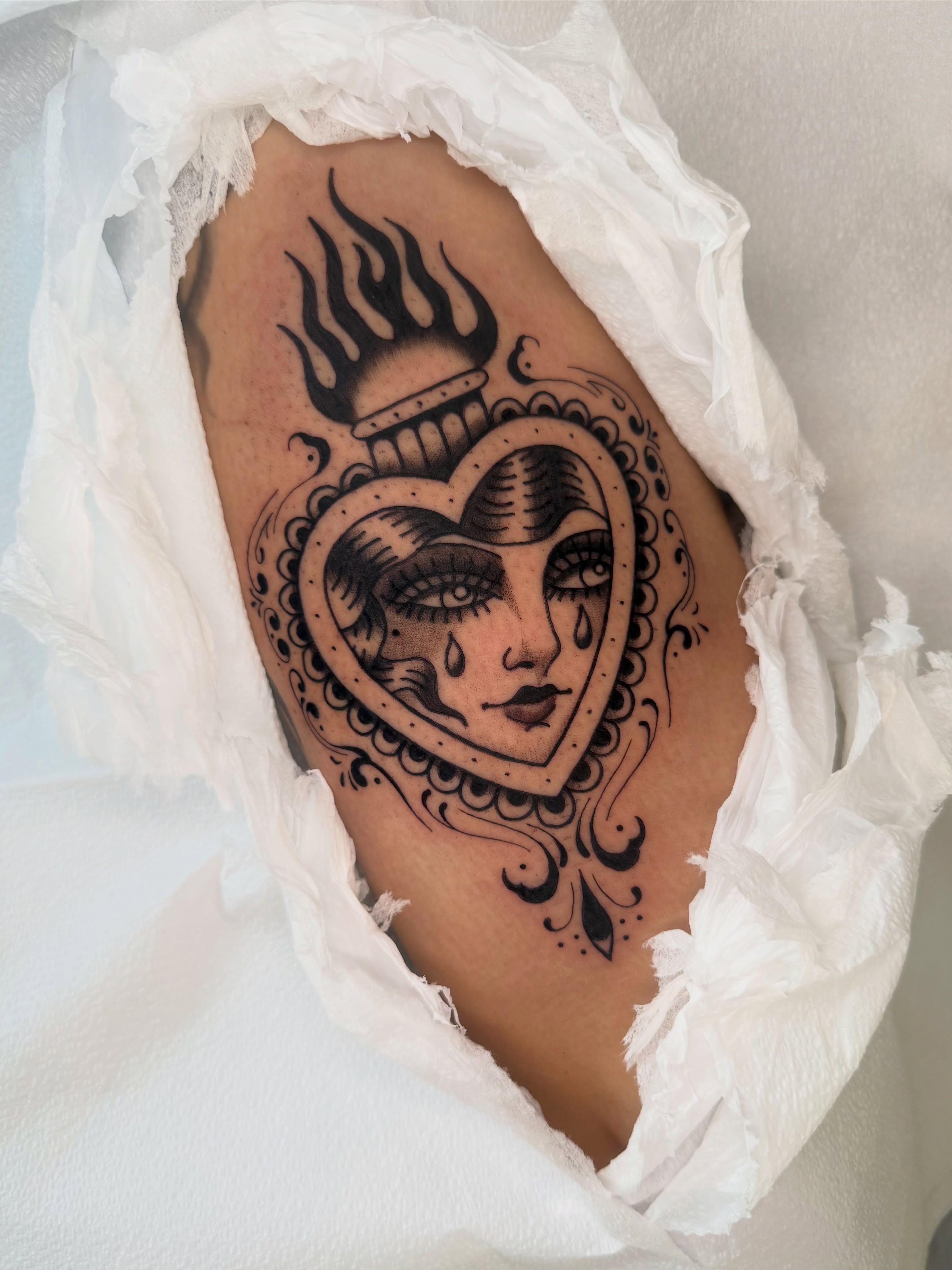 Heart with face ornamental tattoo on the thigh by Lexie Graff