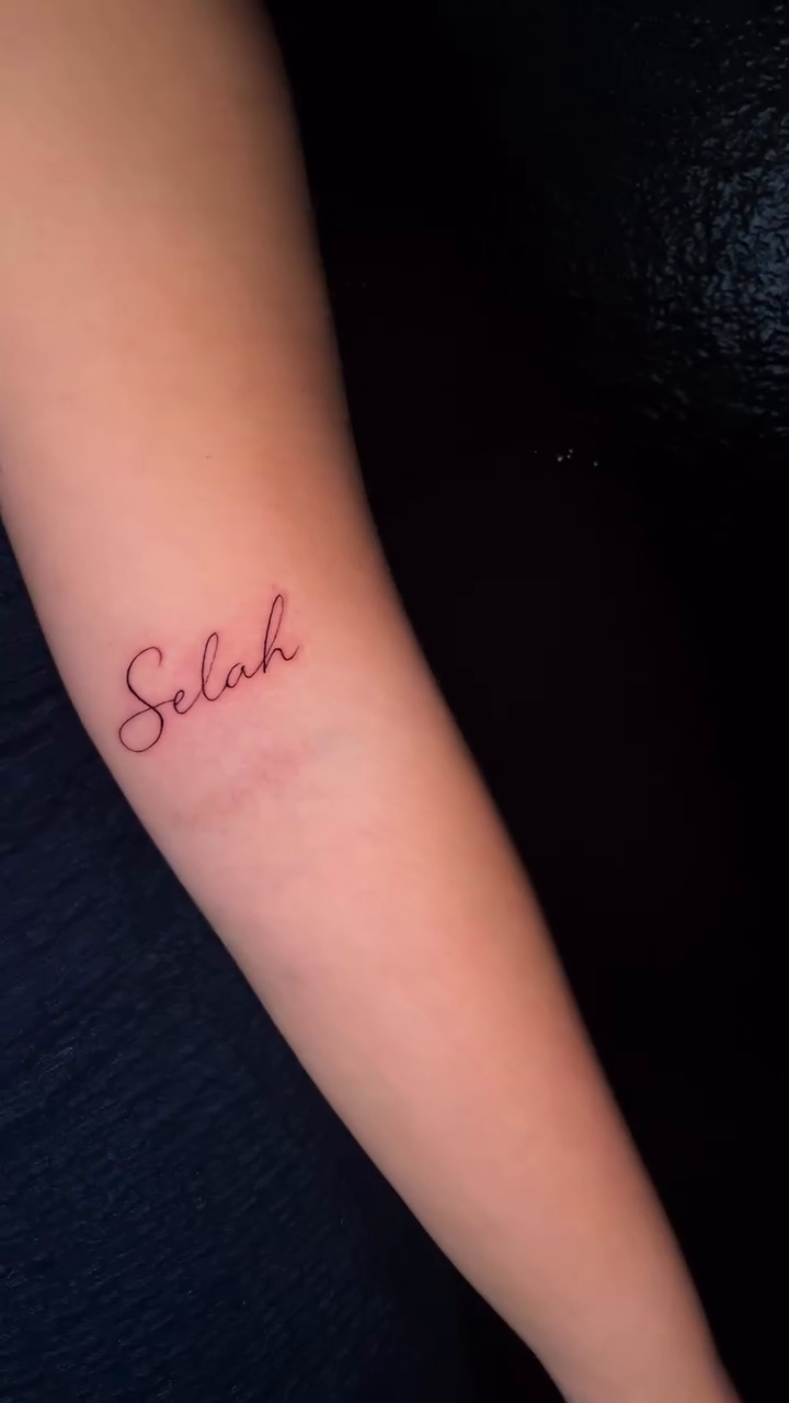 Selah script tattoo on arm lettering tattoo on the forearm by bev