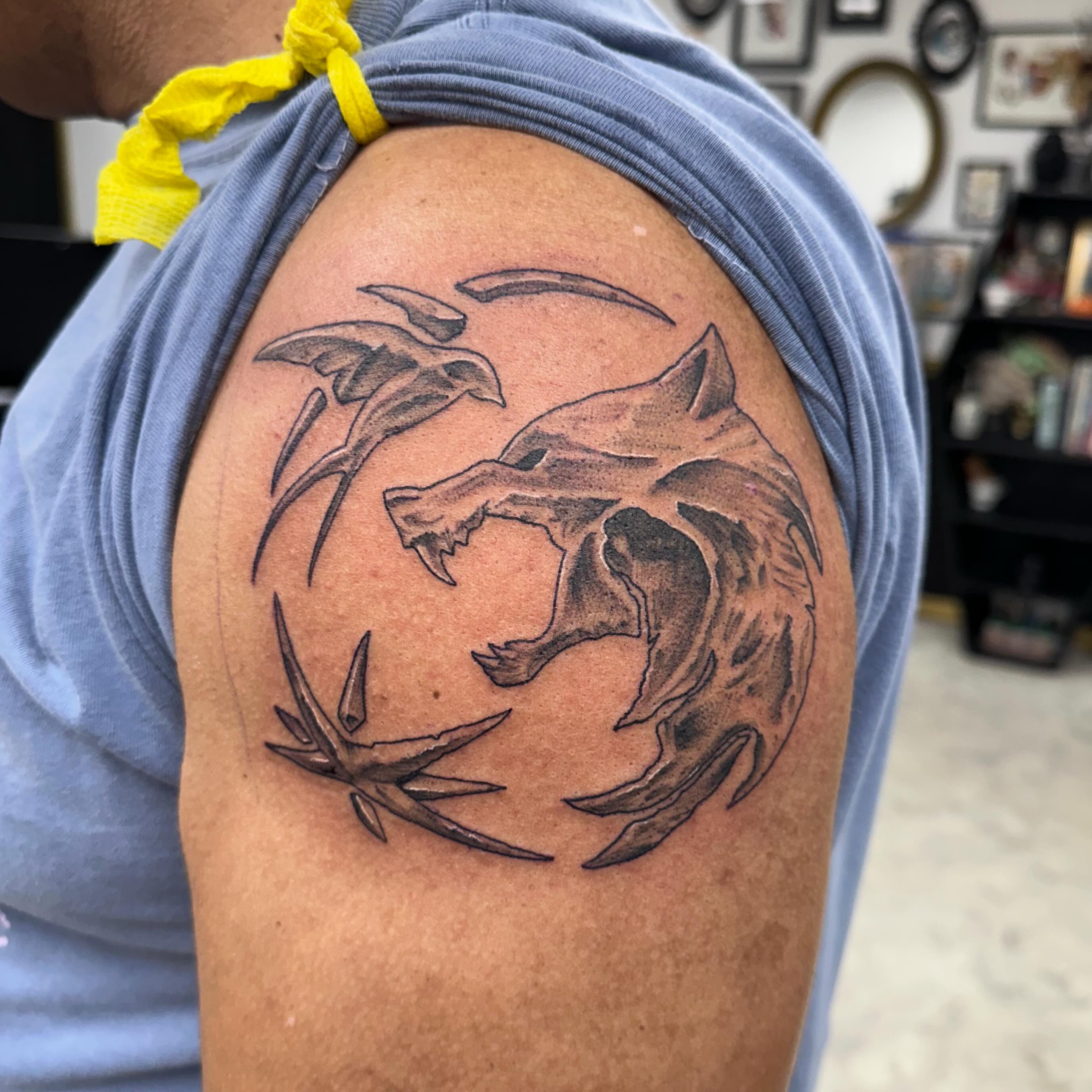 Wolf and thorns black and grey tattoo on the shoulder by Nicki Hoverson