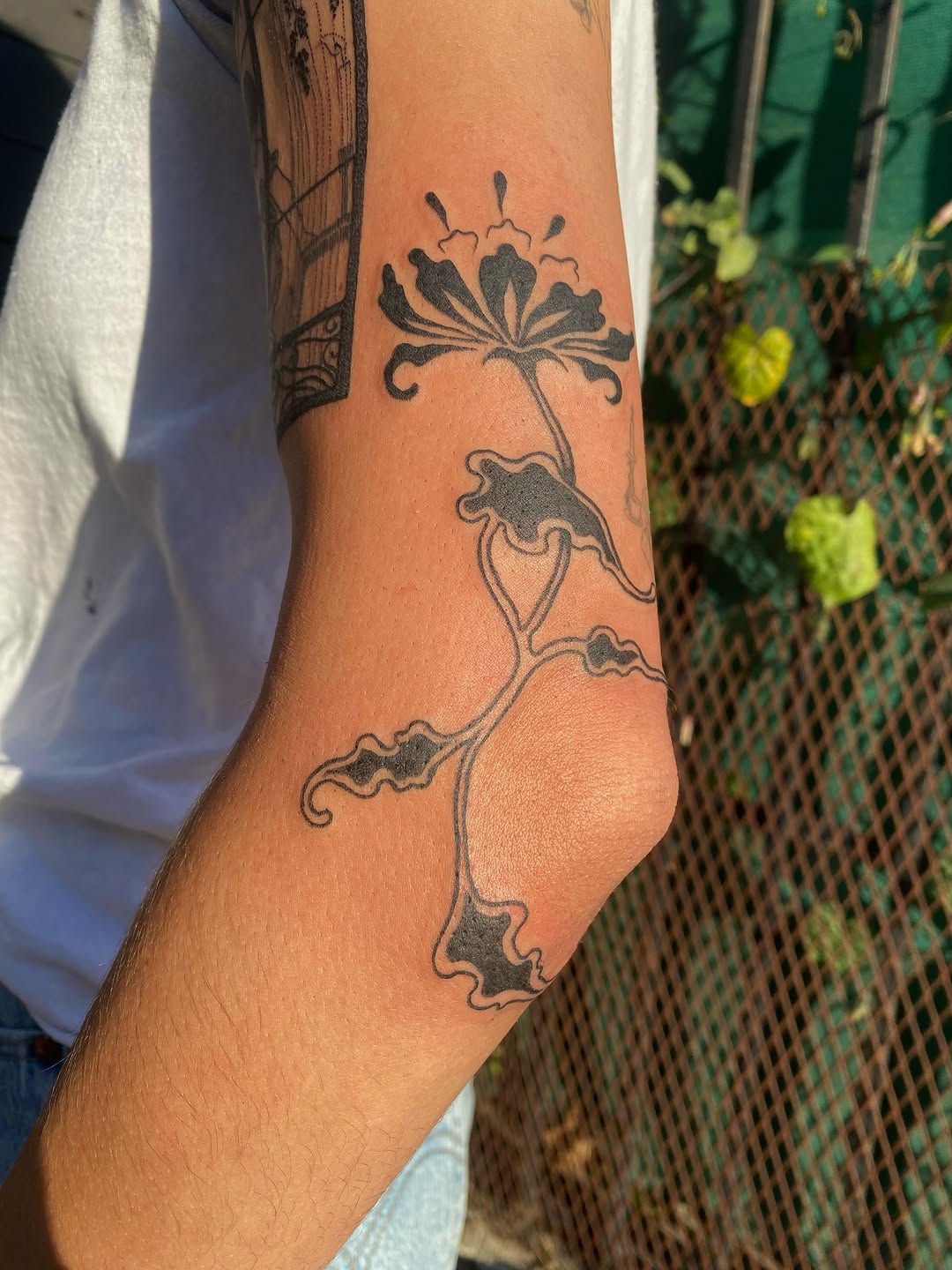Flower fine line tattoo on the forearm by sarah 🗝️