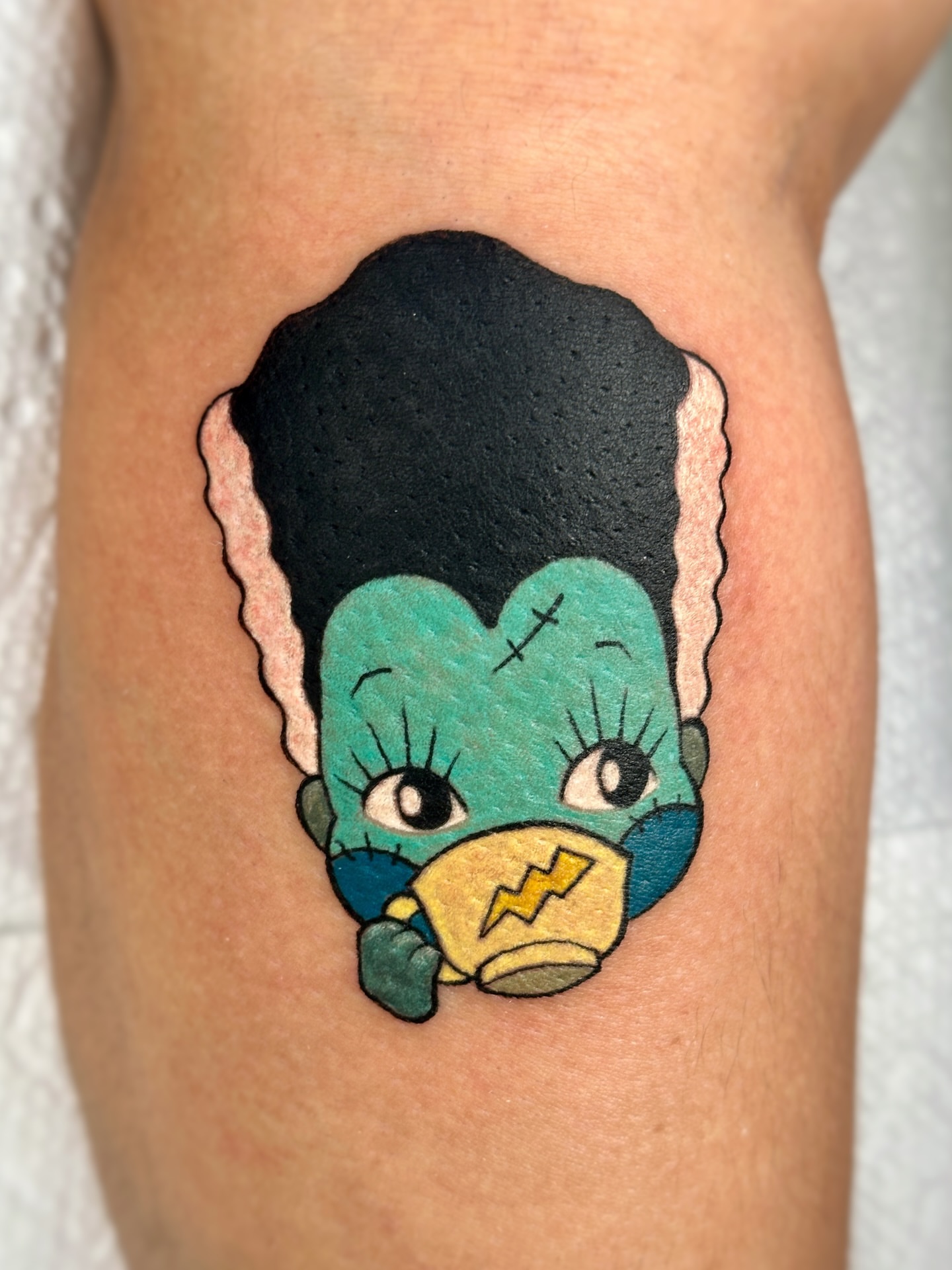 Monster new school tattoo on the thigh by Fernanda Machado
