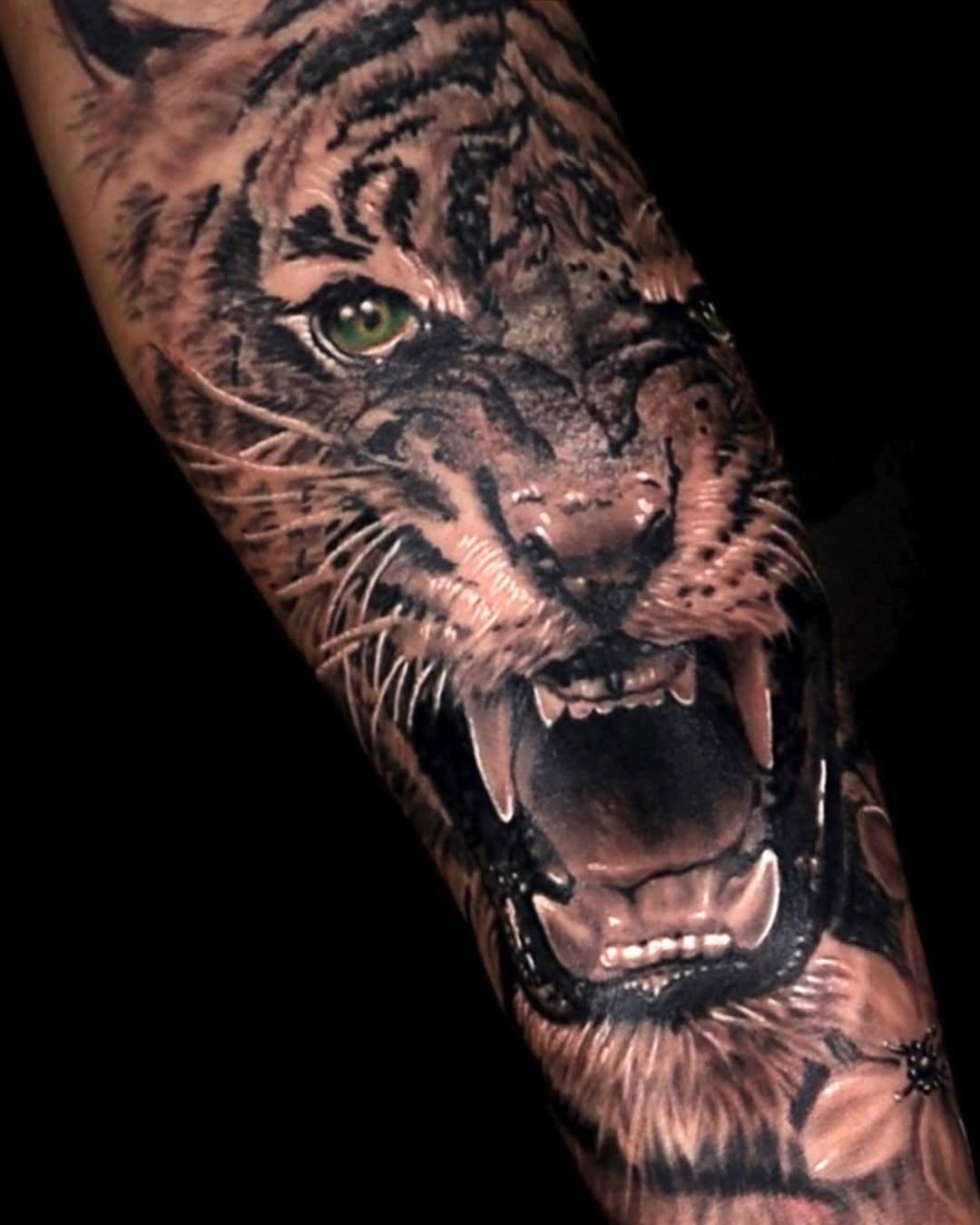 Tiger face realism tattoo on the forearm by Tattoo Artist