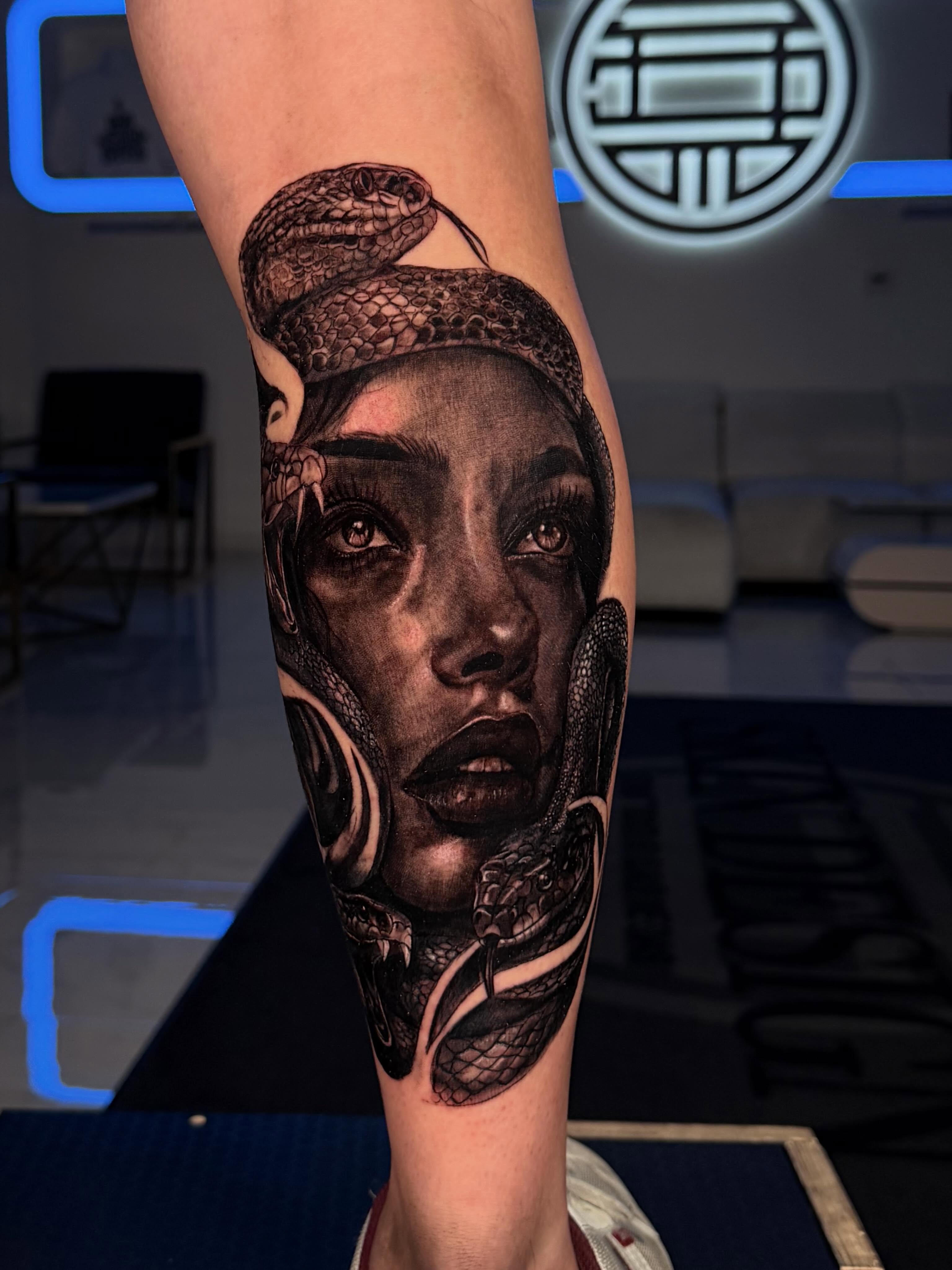 Woman with snake realism tattoo on the forearm by Idalia Pulido