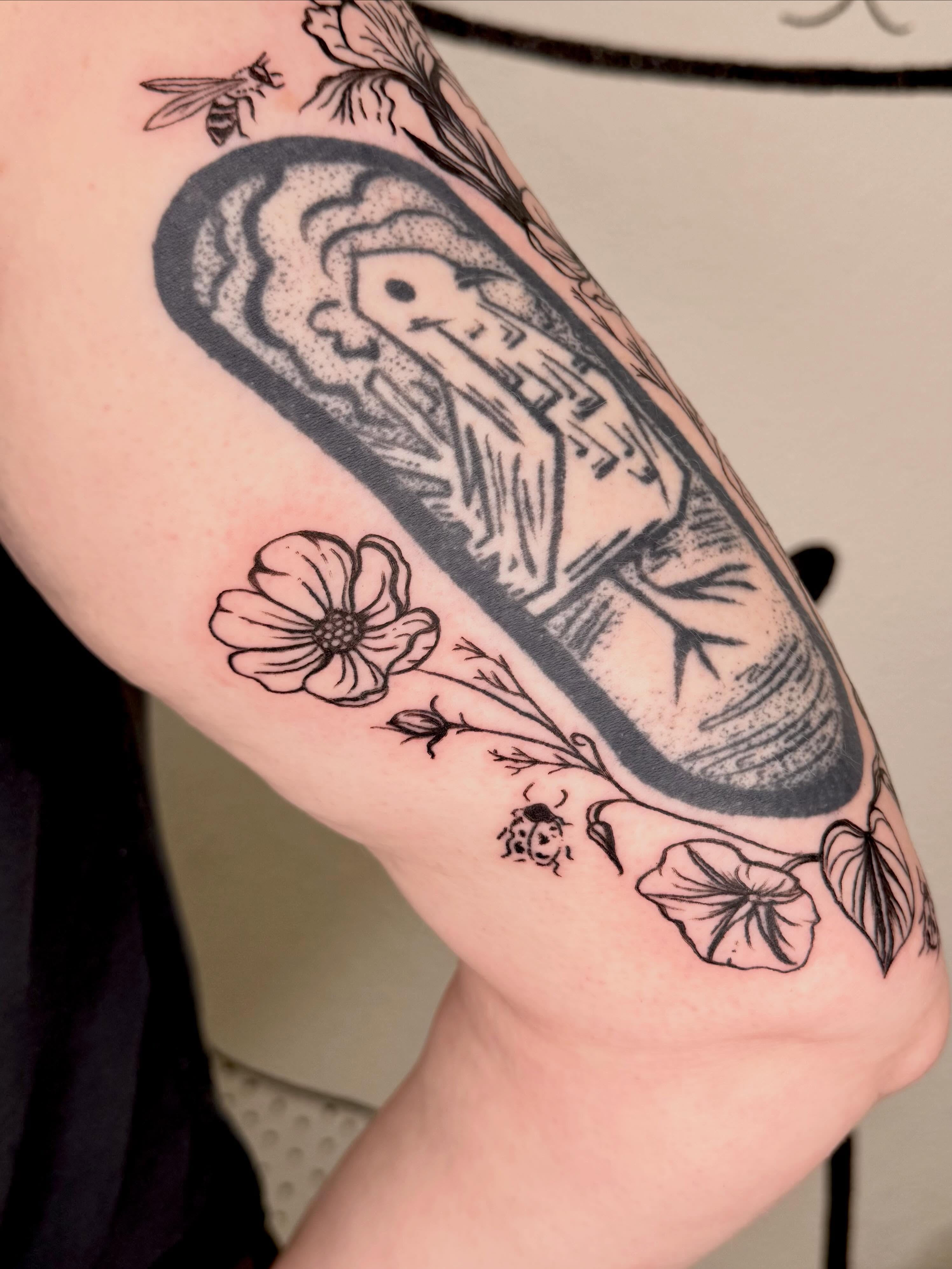 Casket with floral elements dotwork tattoo on the forearm by Peggy