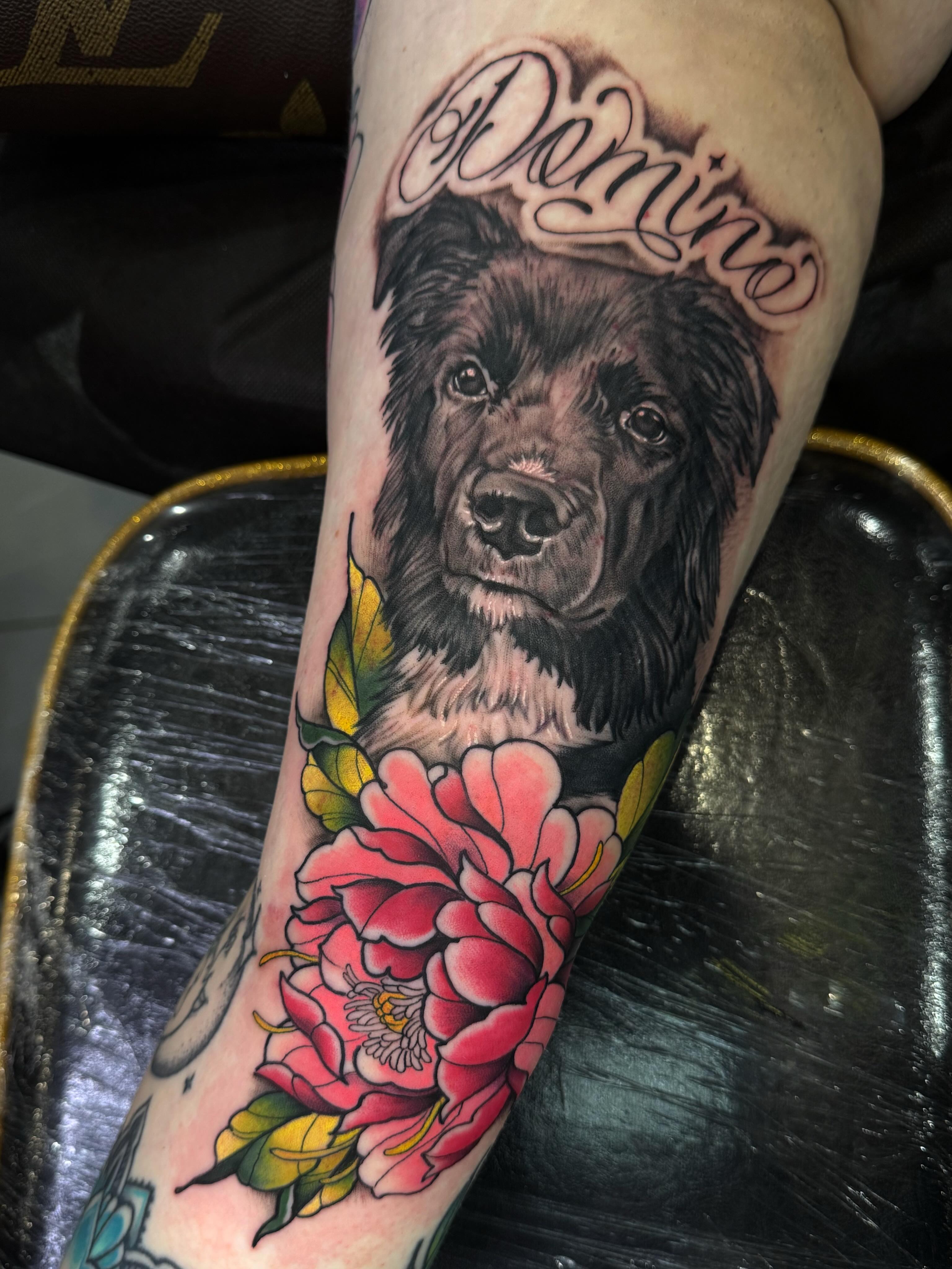 Dog and flowers realism tattoo on the forearm by Ryan Futterman