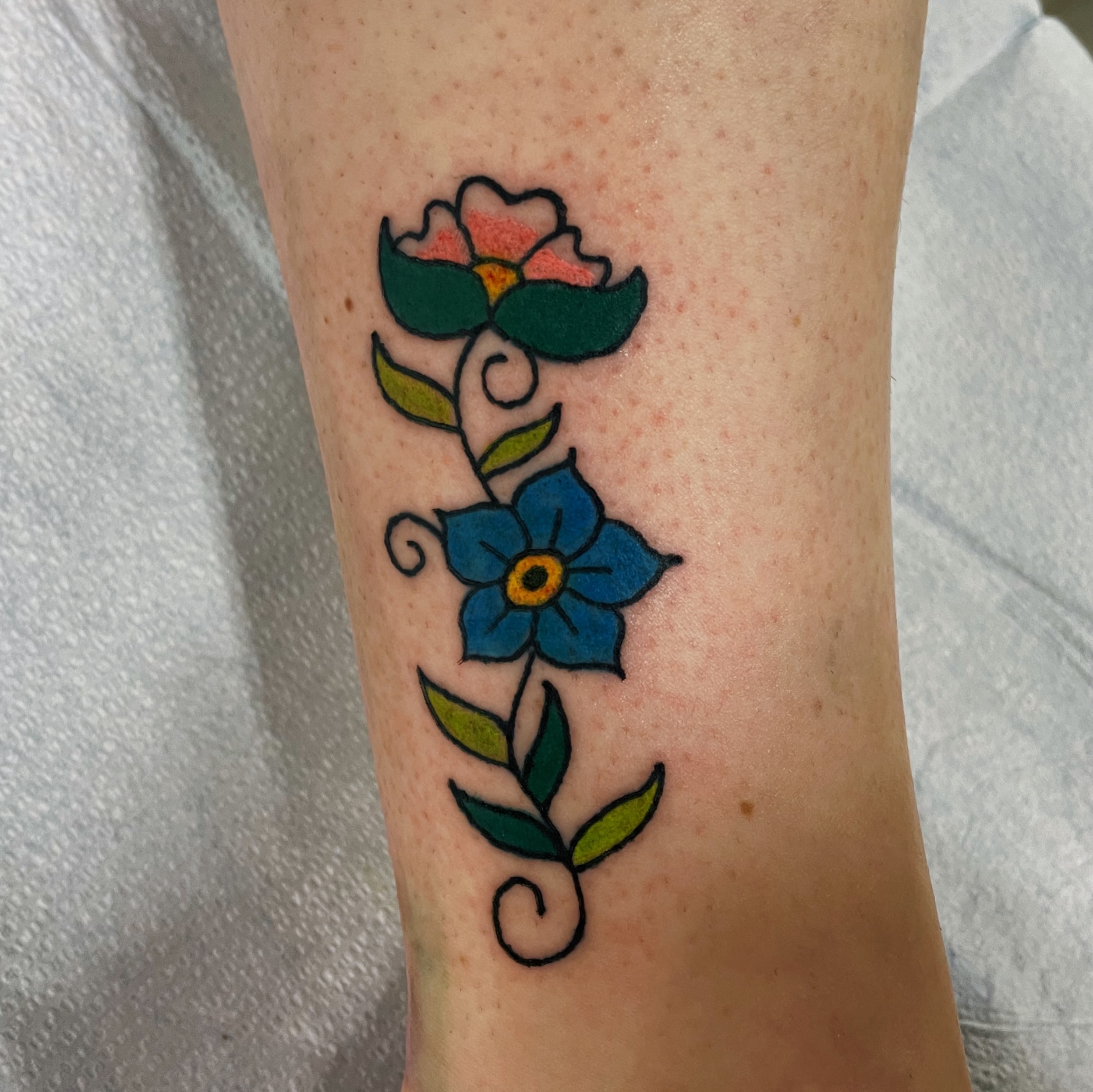 Floral design new school tattoo on the forearm by Glume Tattoo