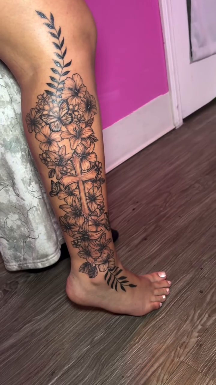 Cross with floral elements on leg fine line tattoo on the leg by Vegas Tattoo Mommy ๐๐, Las Vegas, Nevada