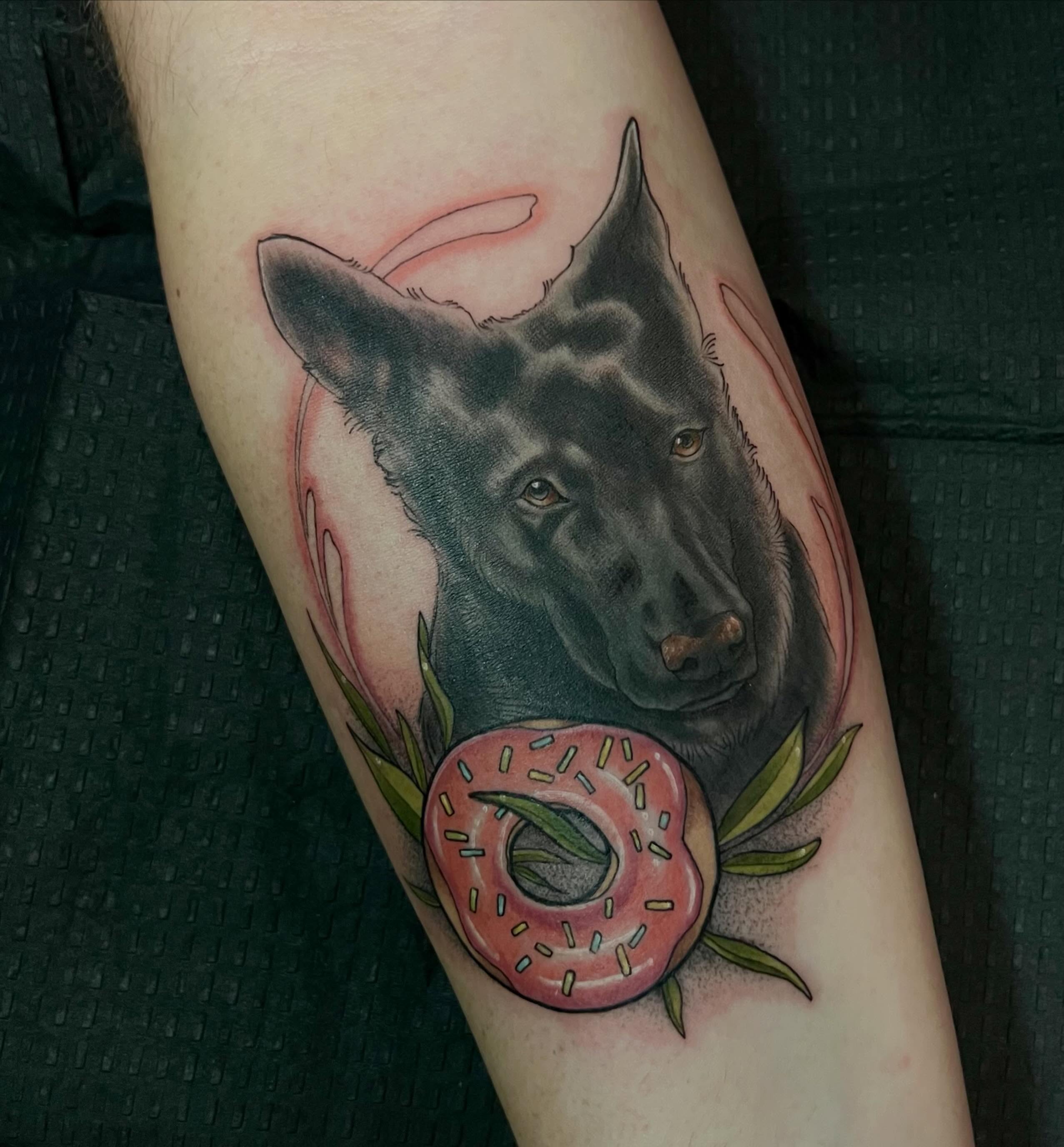 Wolf and donut realism tattoo on the forearm by Em ✨PA Tattooer
