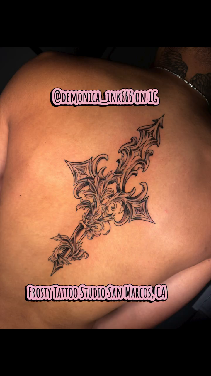 Fleur-de-lis cross tattoo tattoo on the back by Monica Gonzalez