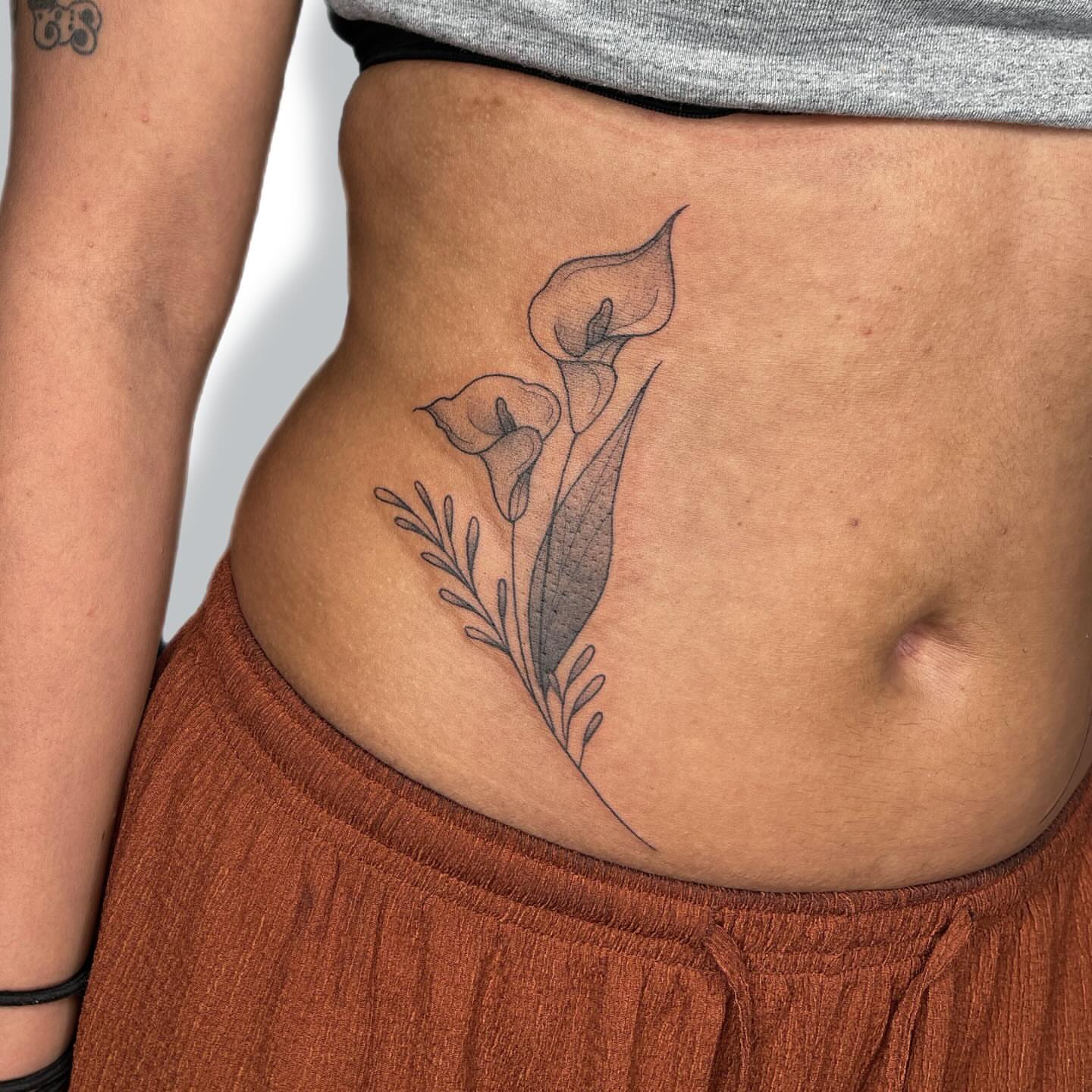 Calla lilies black and grey tattoo on the torso by Jules ๐โโฌ, Chicago, Illinois