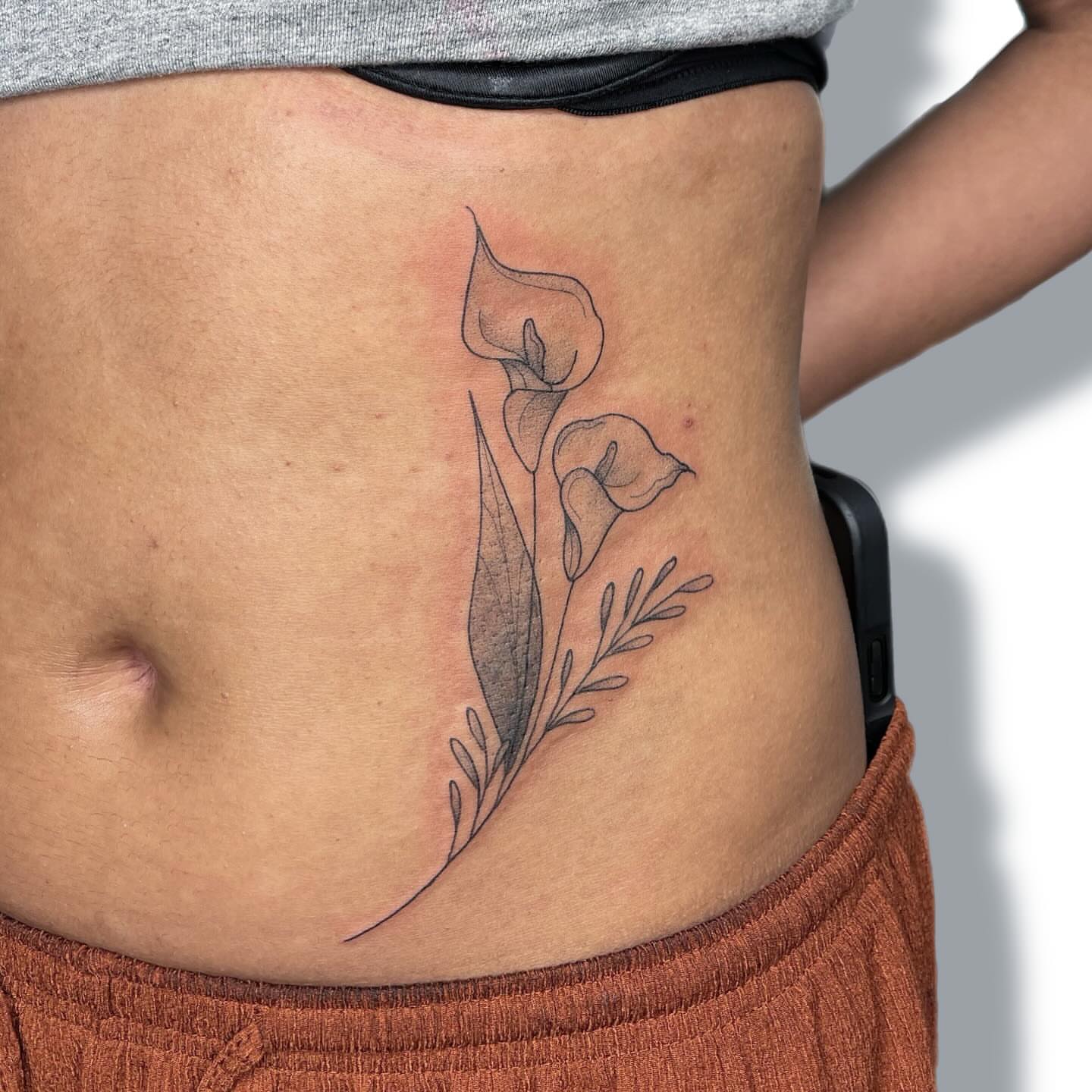 Calla lilies black and grey tattoo on the ribs by Jules ๐โโฌ, Chicago, Illinois