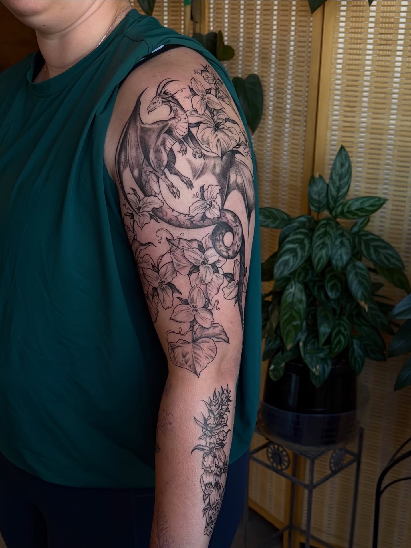 Dragon and flowers black and grey tattoo on the upper arm by emery ♡ slc utah tattoo artist