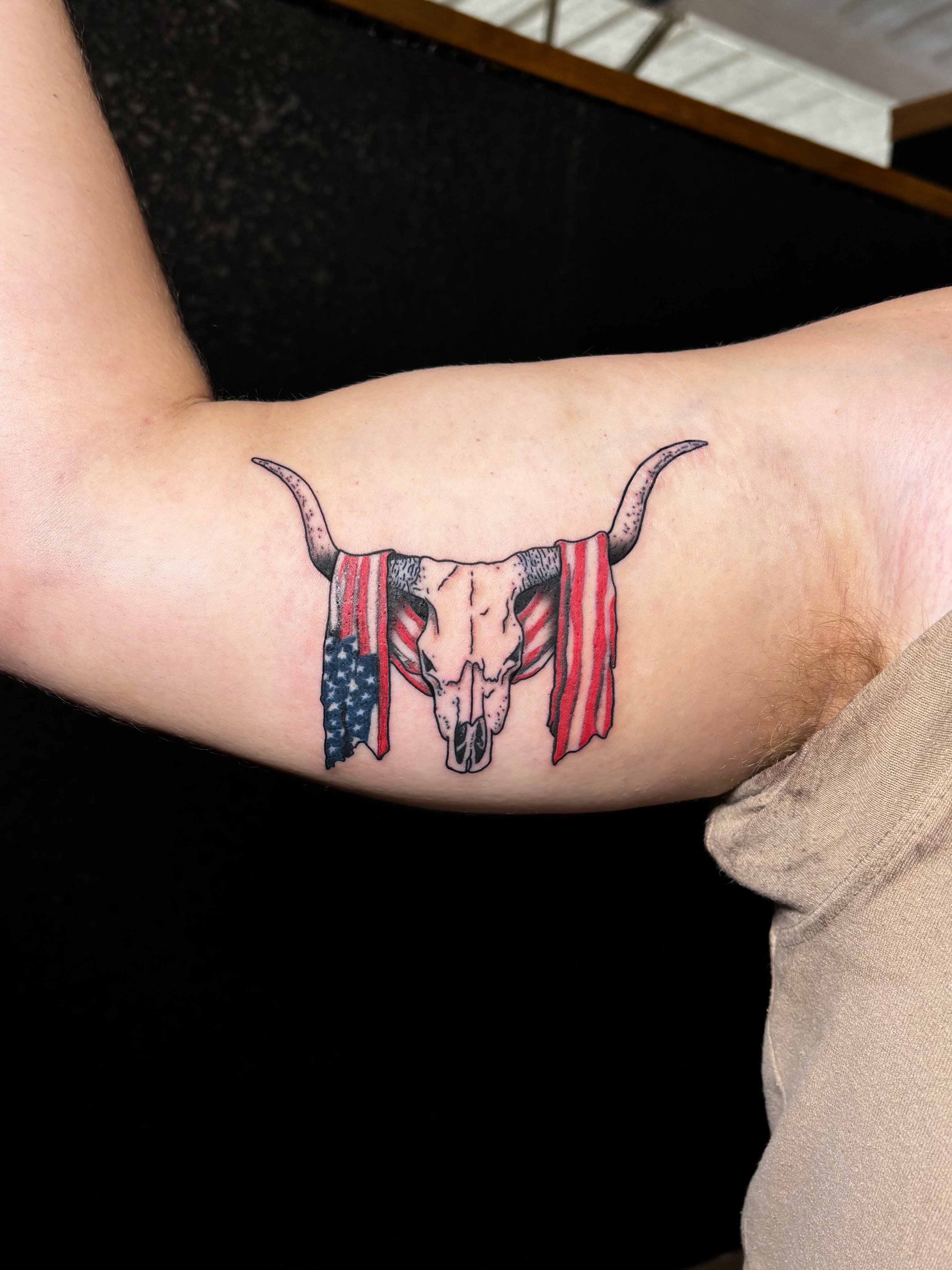 Bull skull with American flag American traditional tattoo on the forearm by JT.tattoos