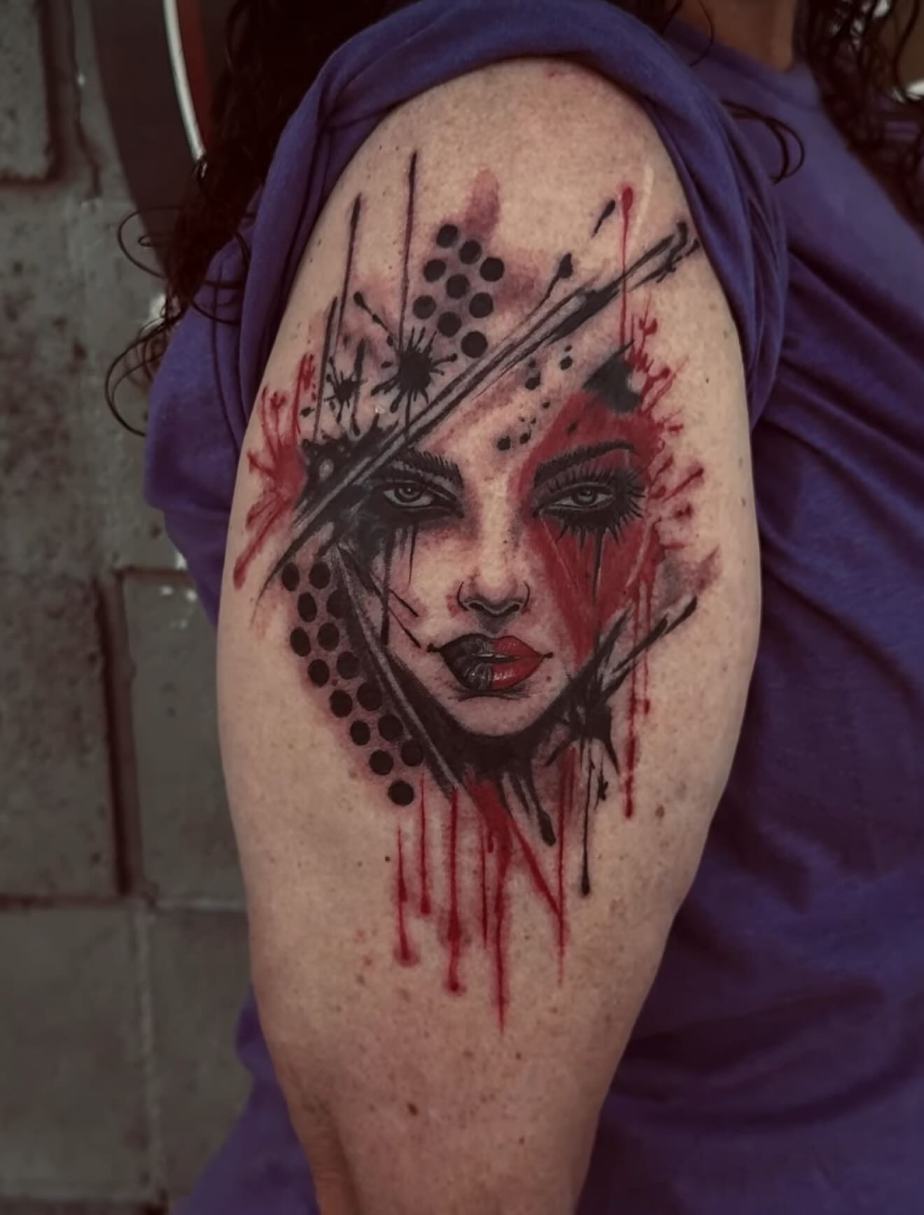 Female face dotwork tattoo on the upper arm by Gary Chase