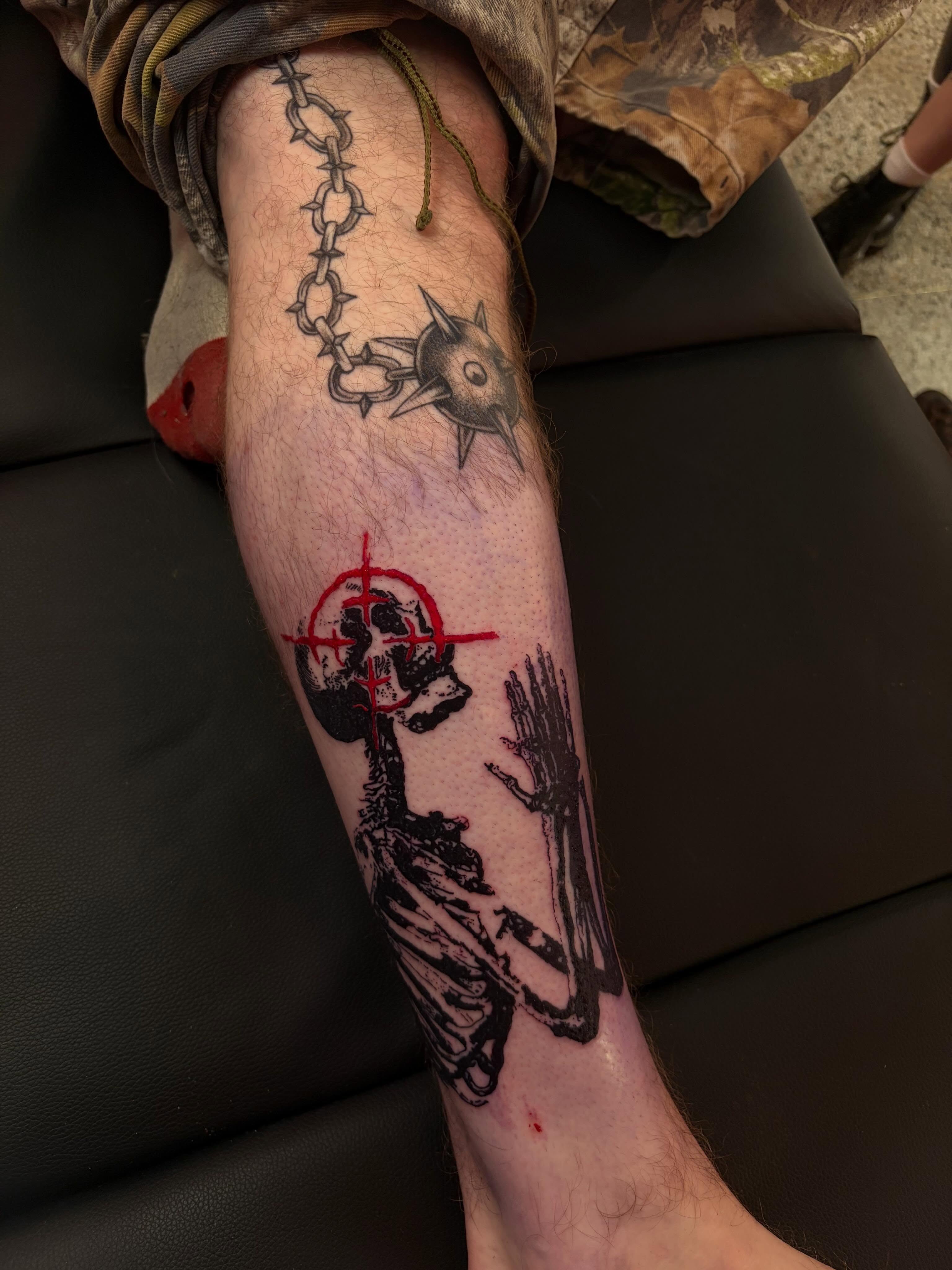 Skull and crossbones black and grey tattoo on the forearm by neal