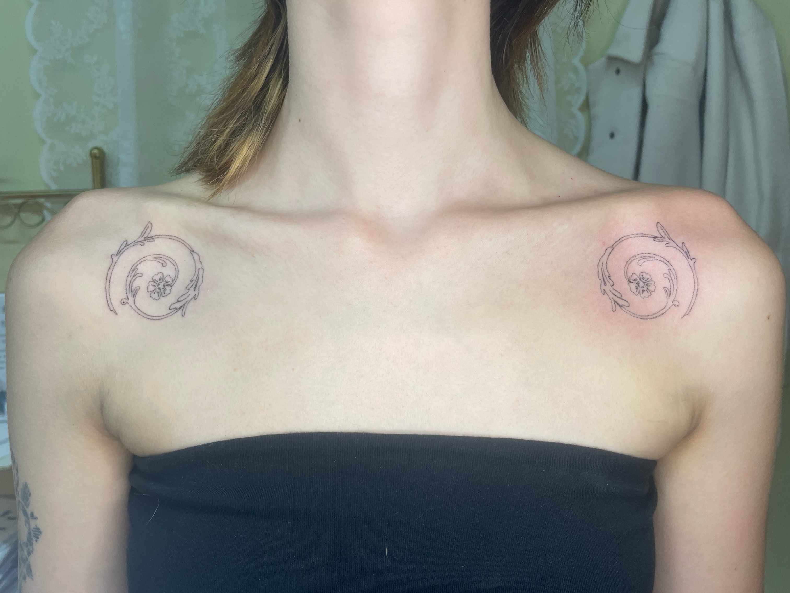 Floral wreath ornamental tattoo on the chest by cait