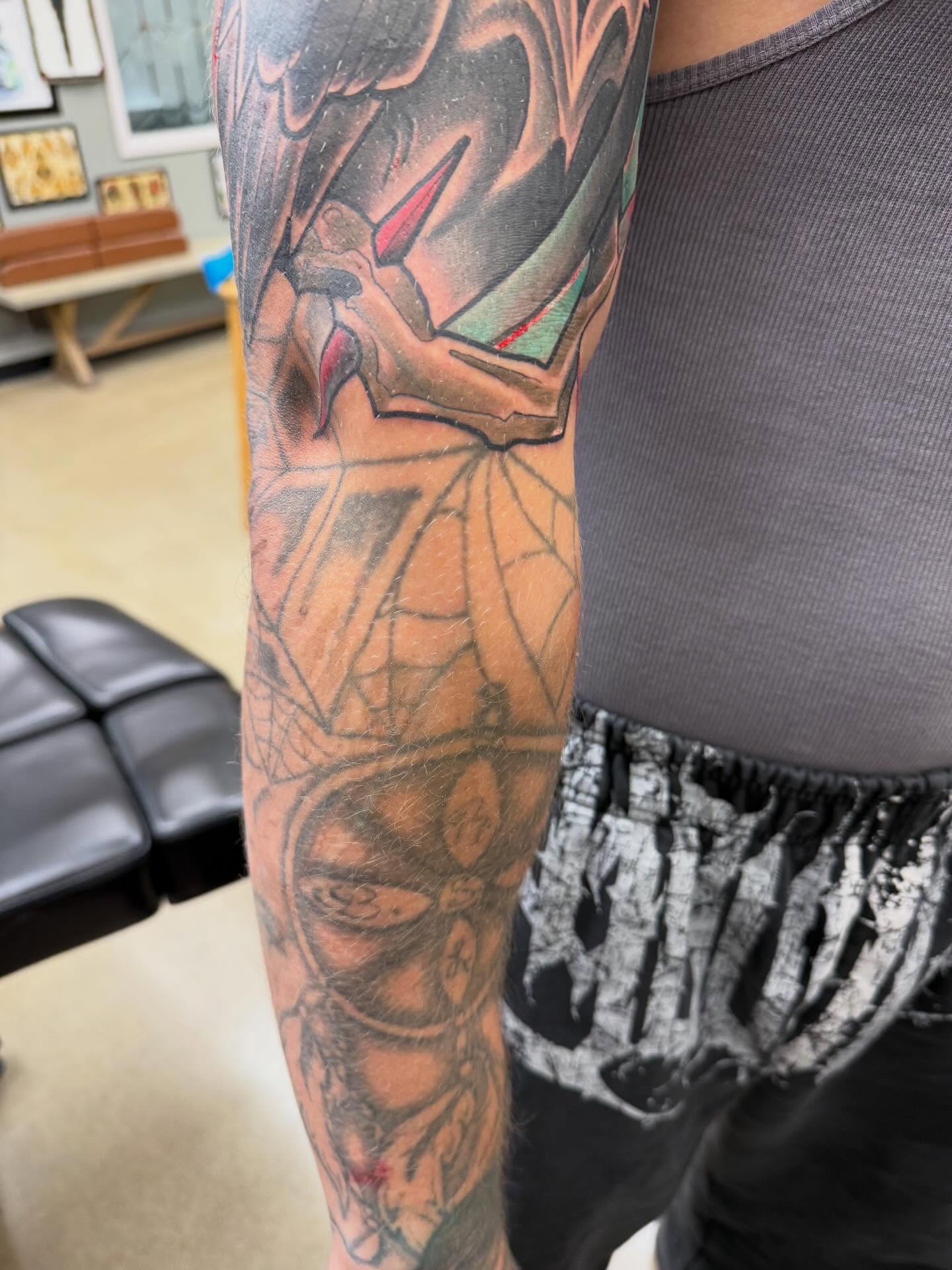 Bat and spiderweb American traditional tattoo on the forearm by Chris Smiseck