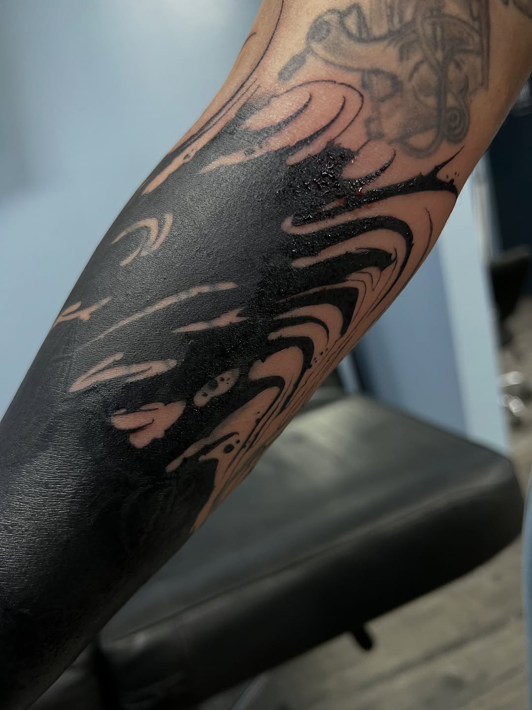 Abstract black ink blackwork tattoo on the forearm by James Foltz
