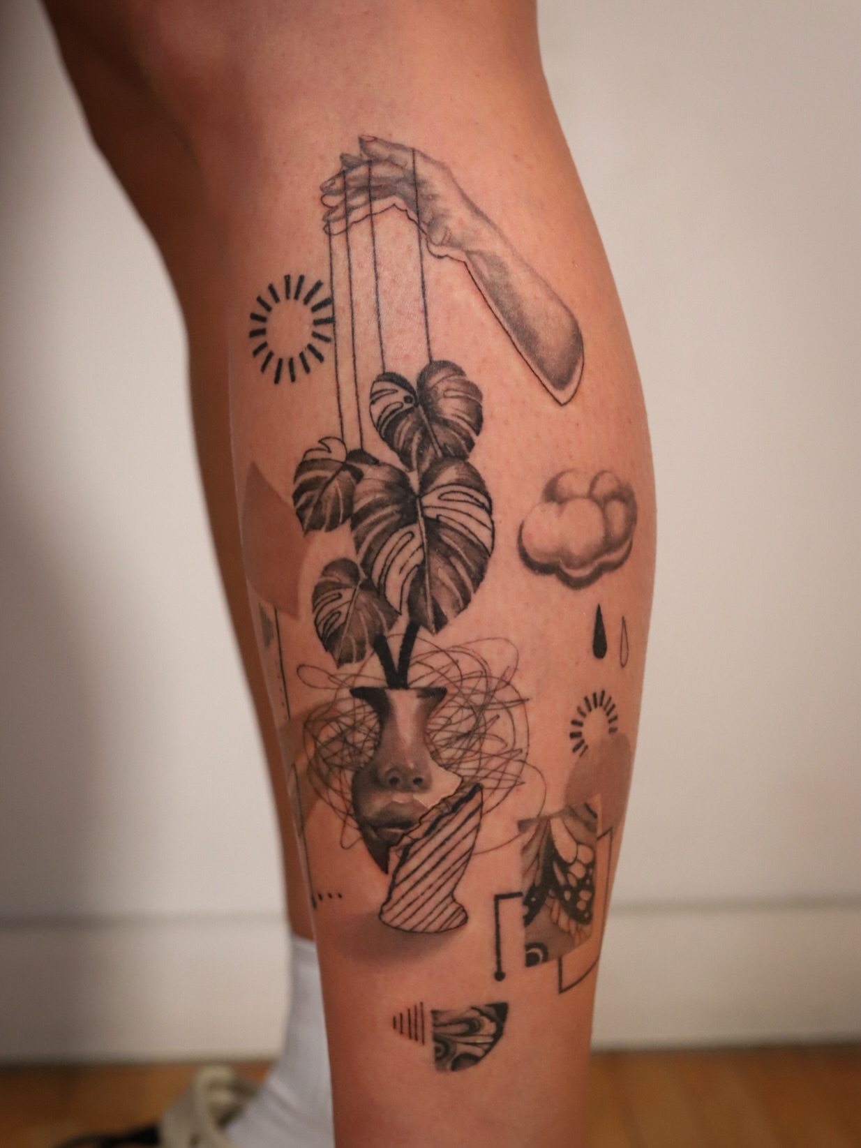 Plant and puppet geometric tattoo on the calf by Dani
