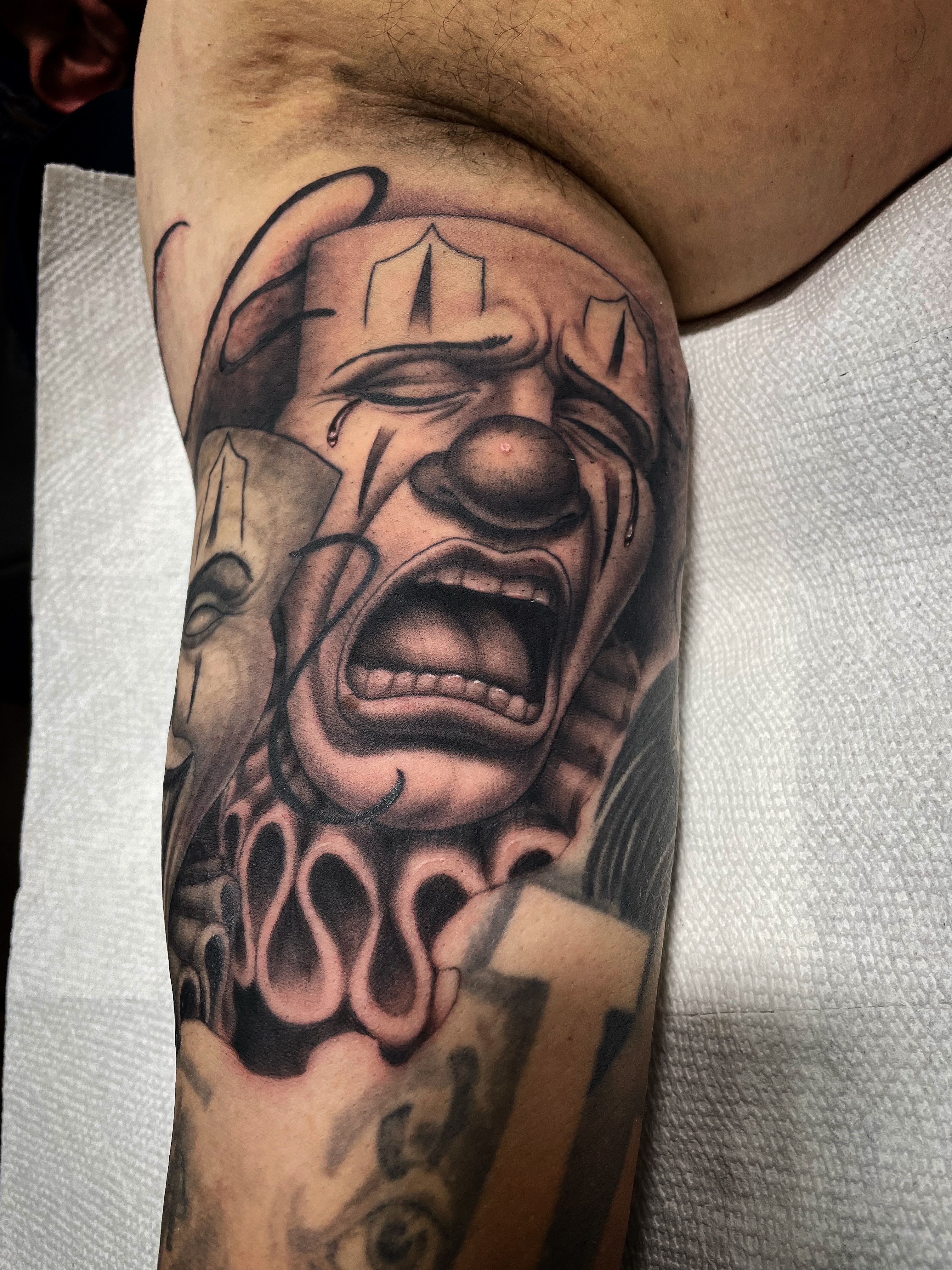 Clown realism tattoo on the forearm by Alex Ortiz