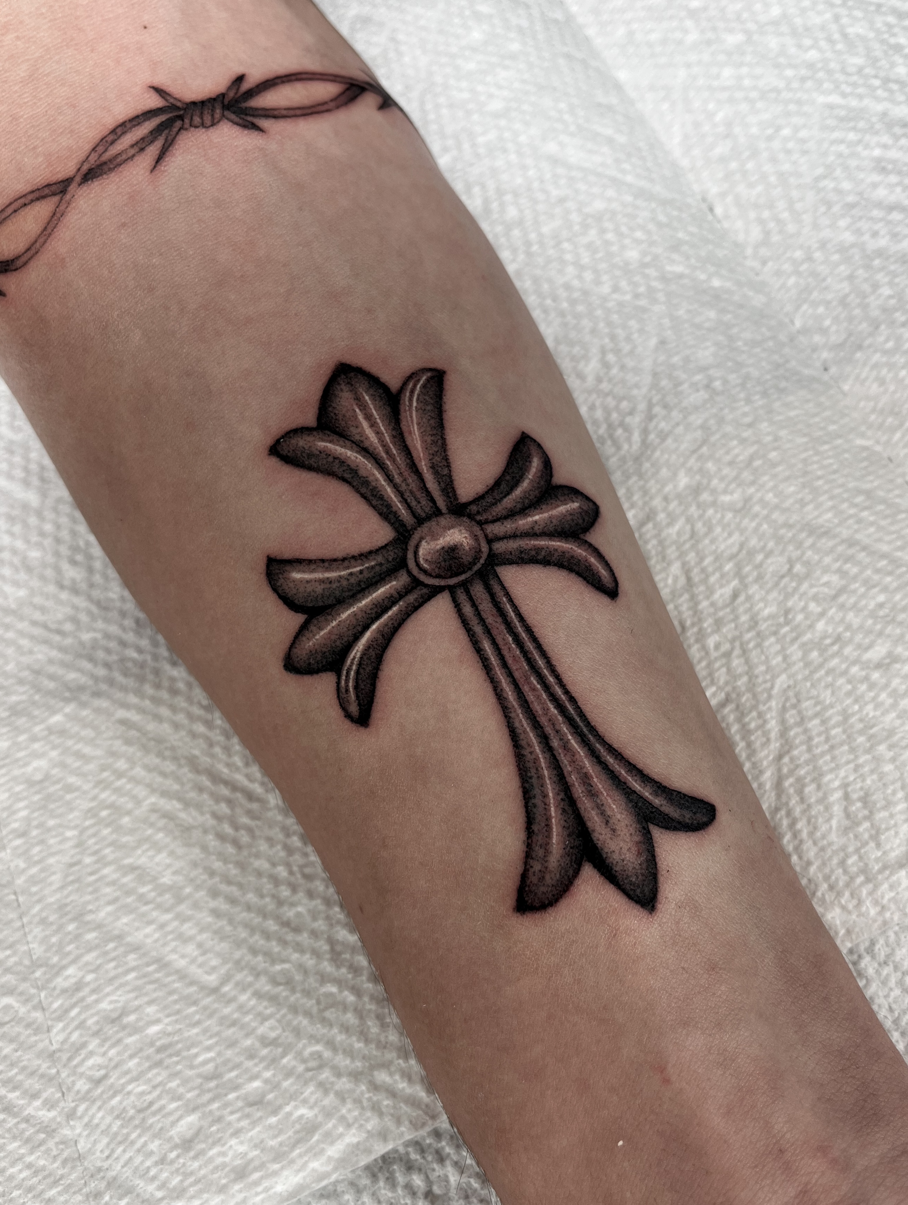 Cross black and grey tattoo on the forearm by The One Who’s Always Drawing