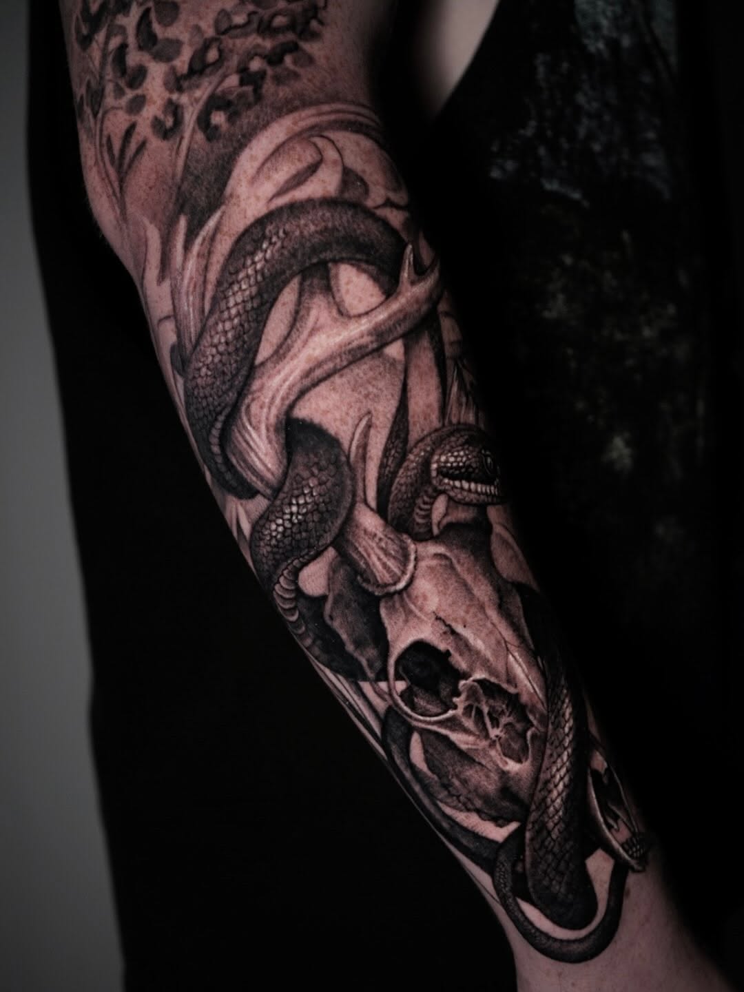 Snake and skull dark art tattoo on the forearm by Sabrina Lakhaysy, Fort Worth, Texas