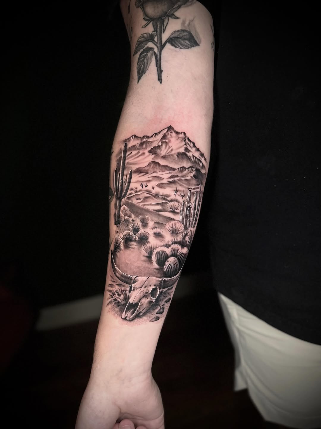 Desert landscape with bull skull fine line tattoo on the forearm by Terence Taylor