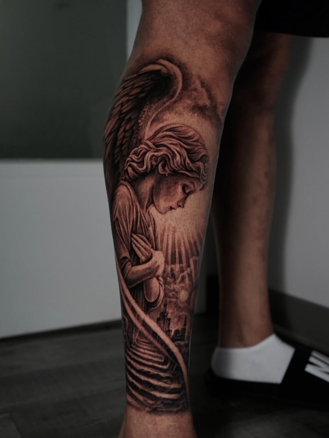 Angel with wings and cityscape realism tattoo on the forearm by Sabrina Lakhaysy, Fort Worth, Texas