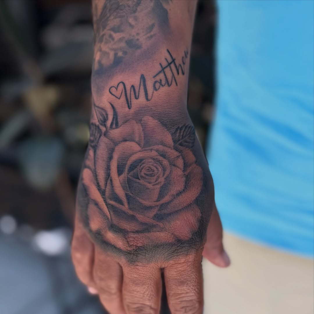 Rose black and grey tattoo on the hand by Faith Lopez