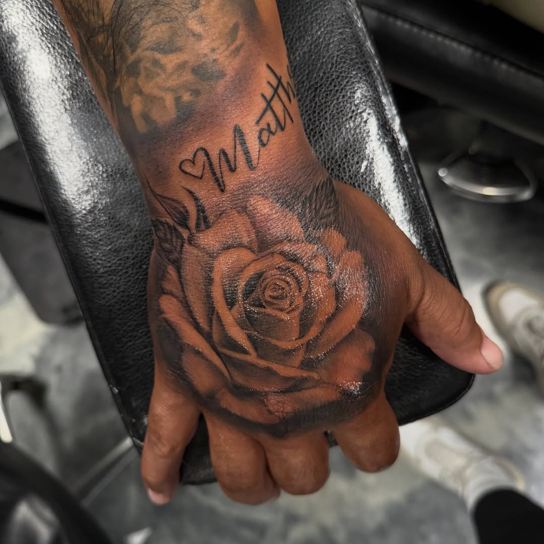 Rose black and grey tattoo on the hand by Faith Lopez