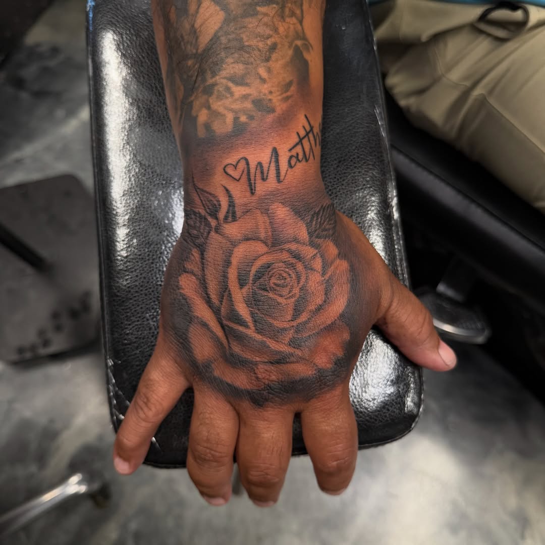 Rose black and grey tattoo on the hand by Faith Lopez