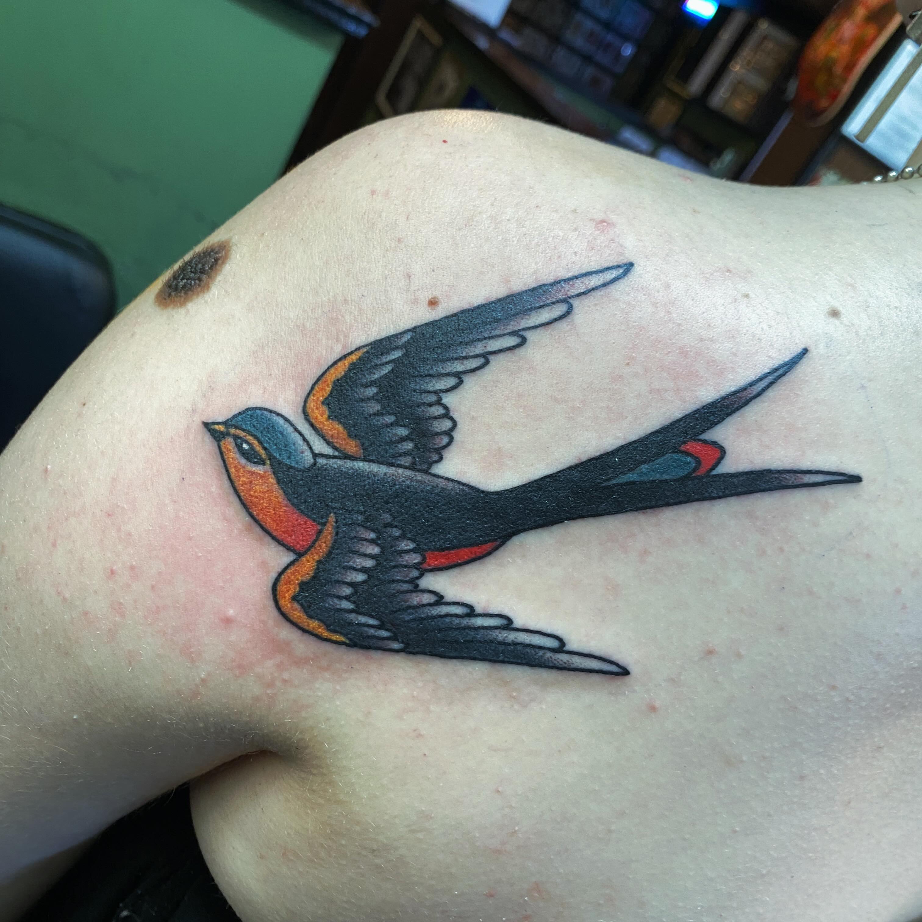 Swallow American traditional tattoo on the shoulder by Houston tattoo artist