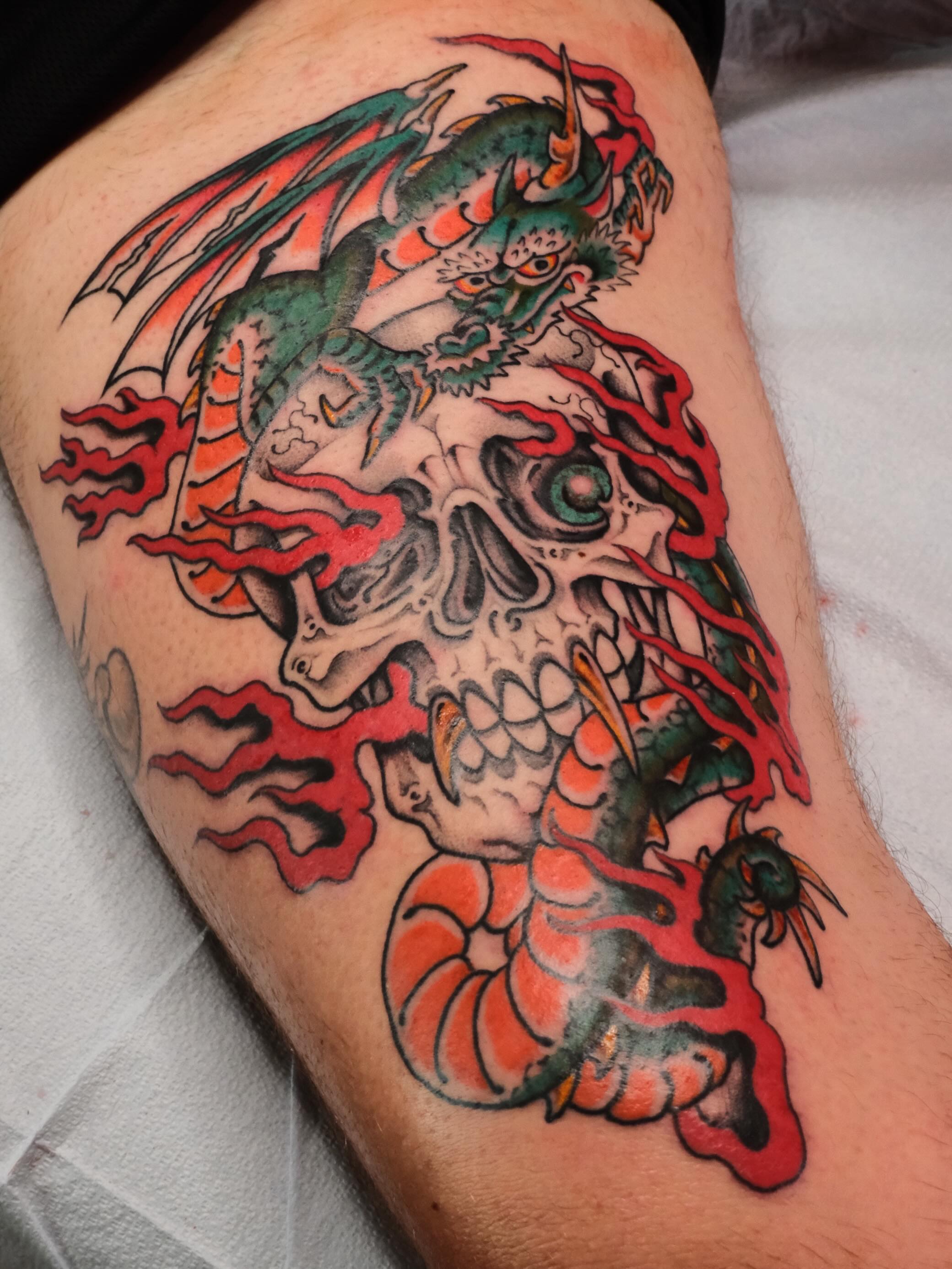 Skull and dragon American traditional tattoo on the thigh by B
