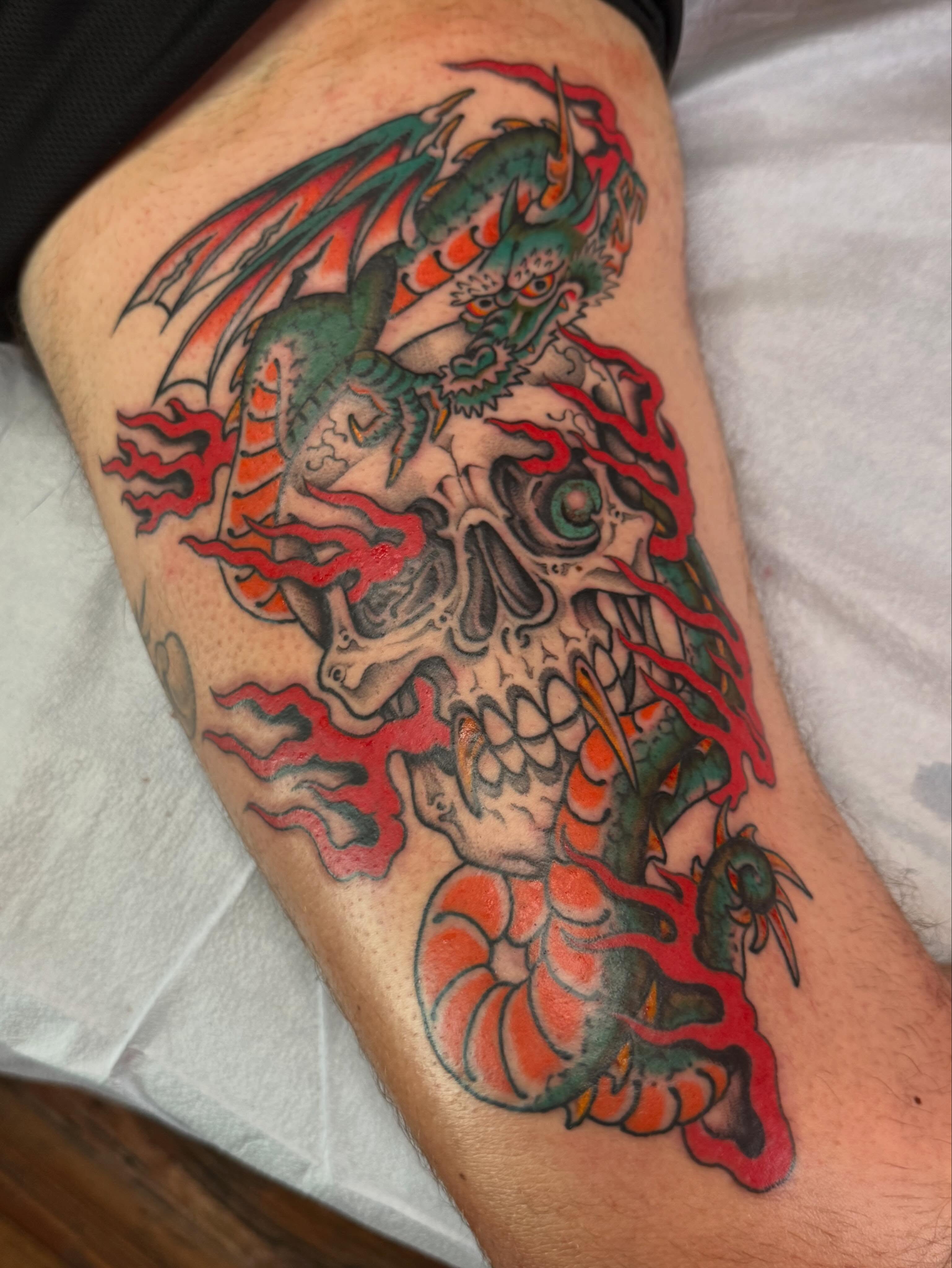 Skull with dragon American traditional tattoo on the forearm by B