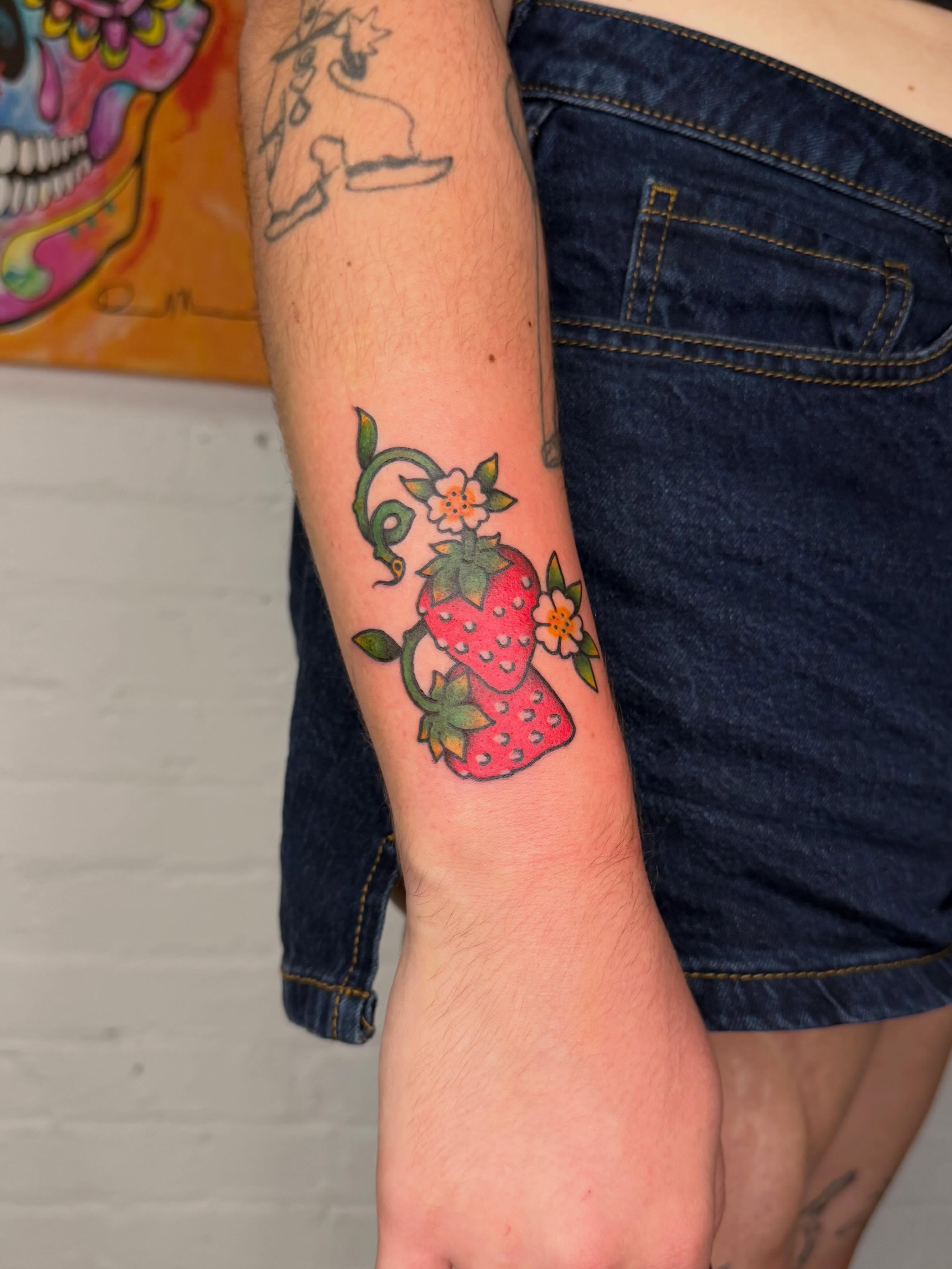 Strawberries and flowers American traditional tattoo on the forearm by Dennis Patterson