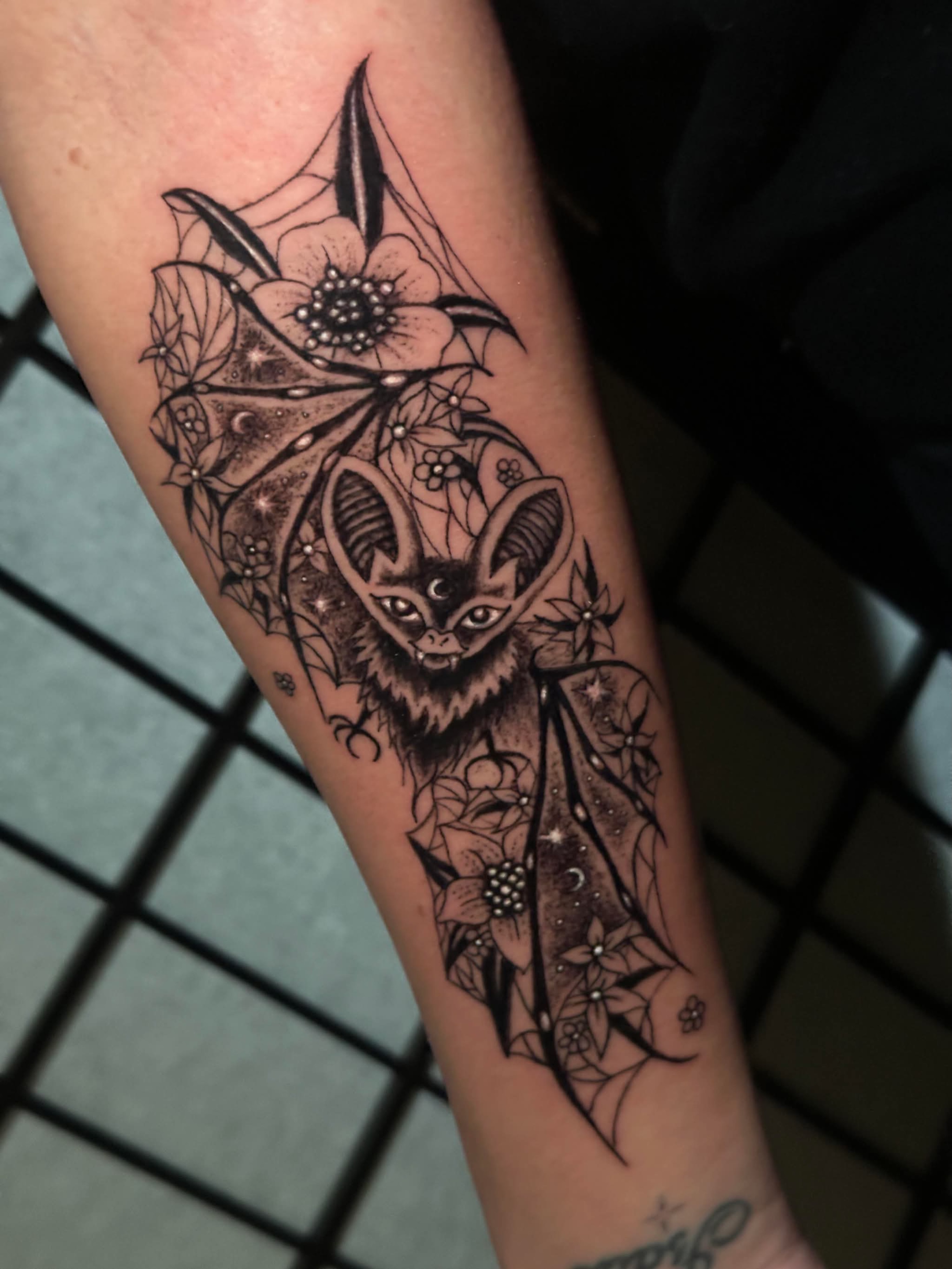 Bat and flowers geometric tattoo on the forearm by Chris Whittaker Tattoo Artist